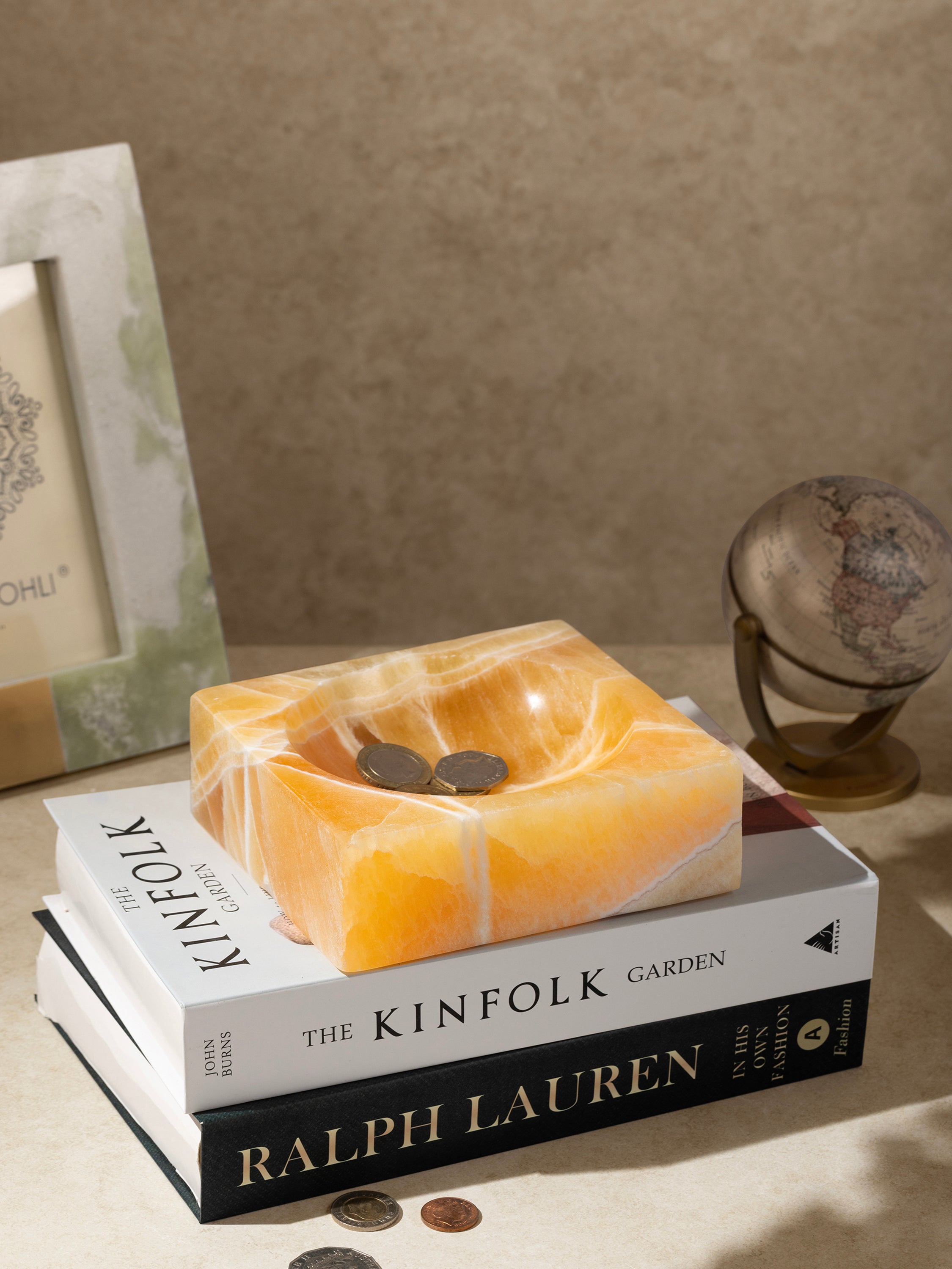 Semi-precious onyx bowl styled on console with jewelry