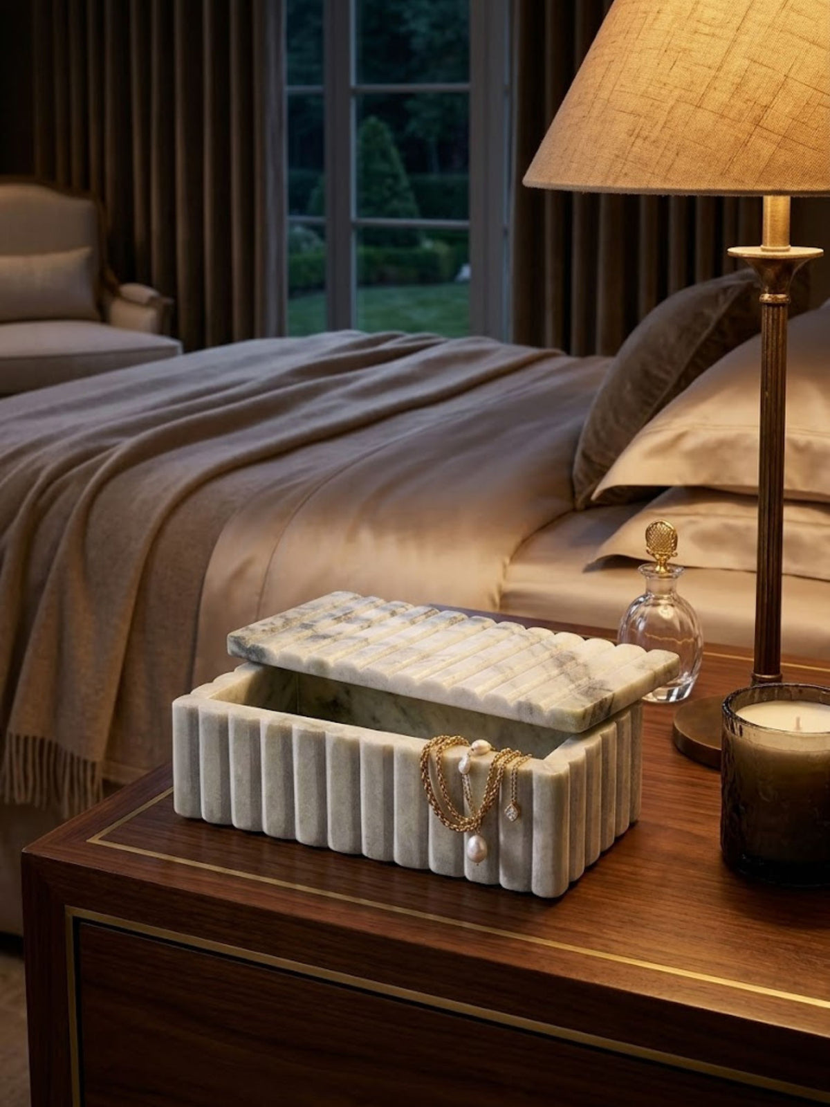 Pale grey-green onyx box with fluted detailing, styled as a jewelry box on a vanity top.