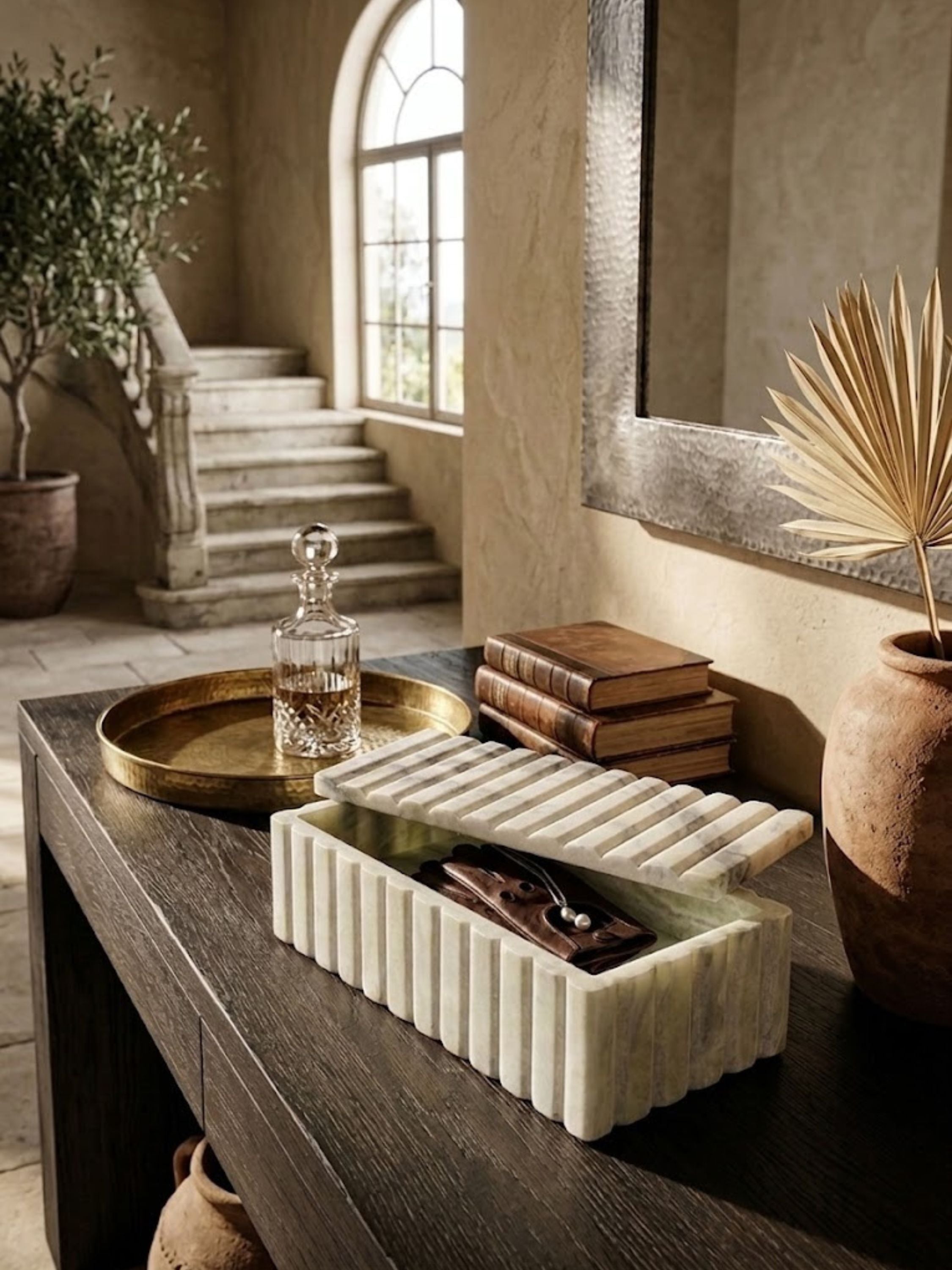 Pale grey-green onyx ribbed box styled on a table alongside upholstered seating.