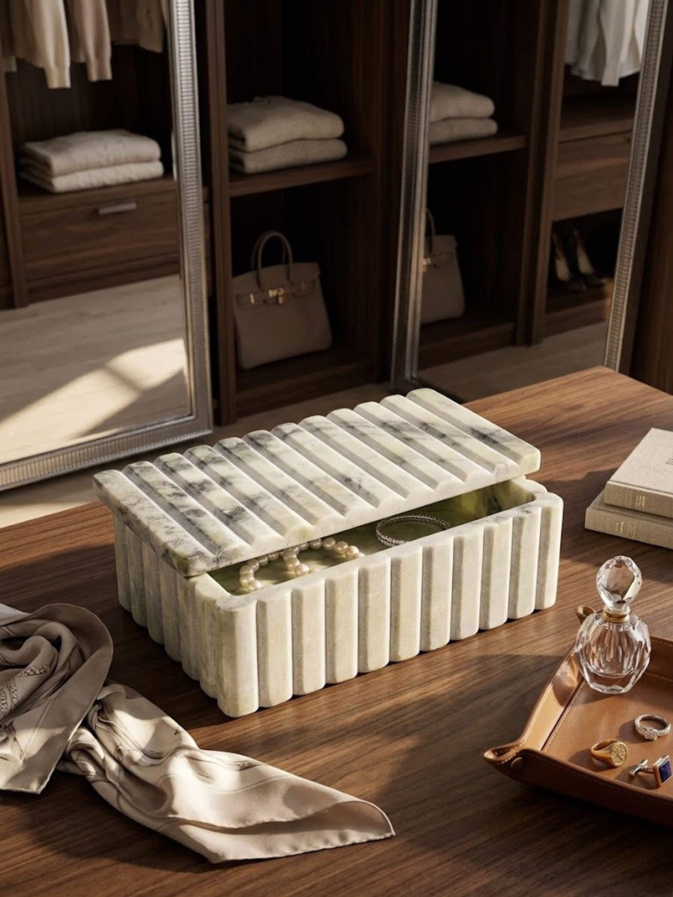 Pale grey-green onyx ribbed box styled on a vanity alongside everyday objects.