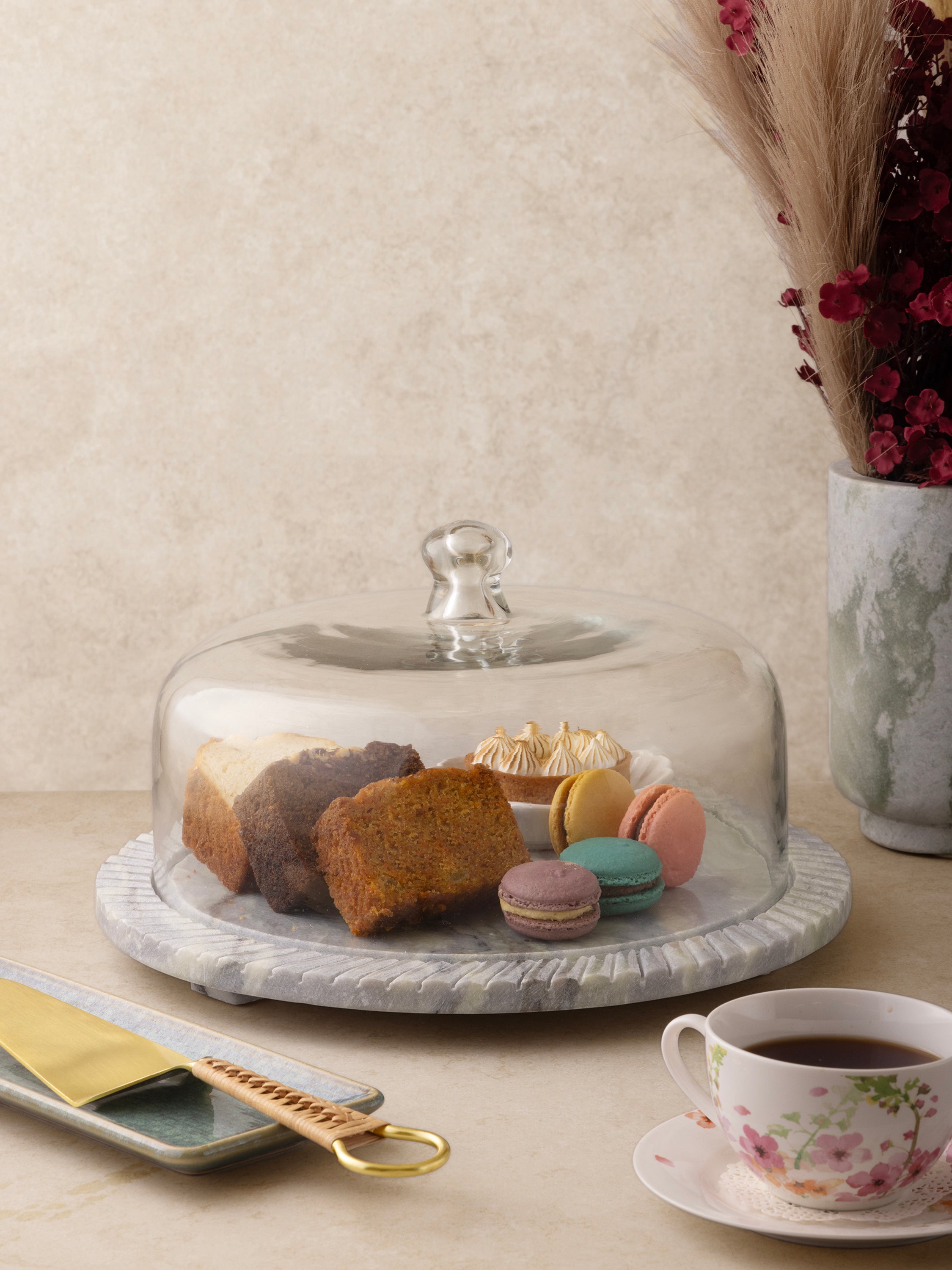 Serving board styled with cheese and fruit under cloche