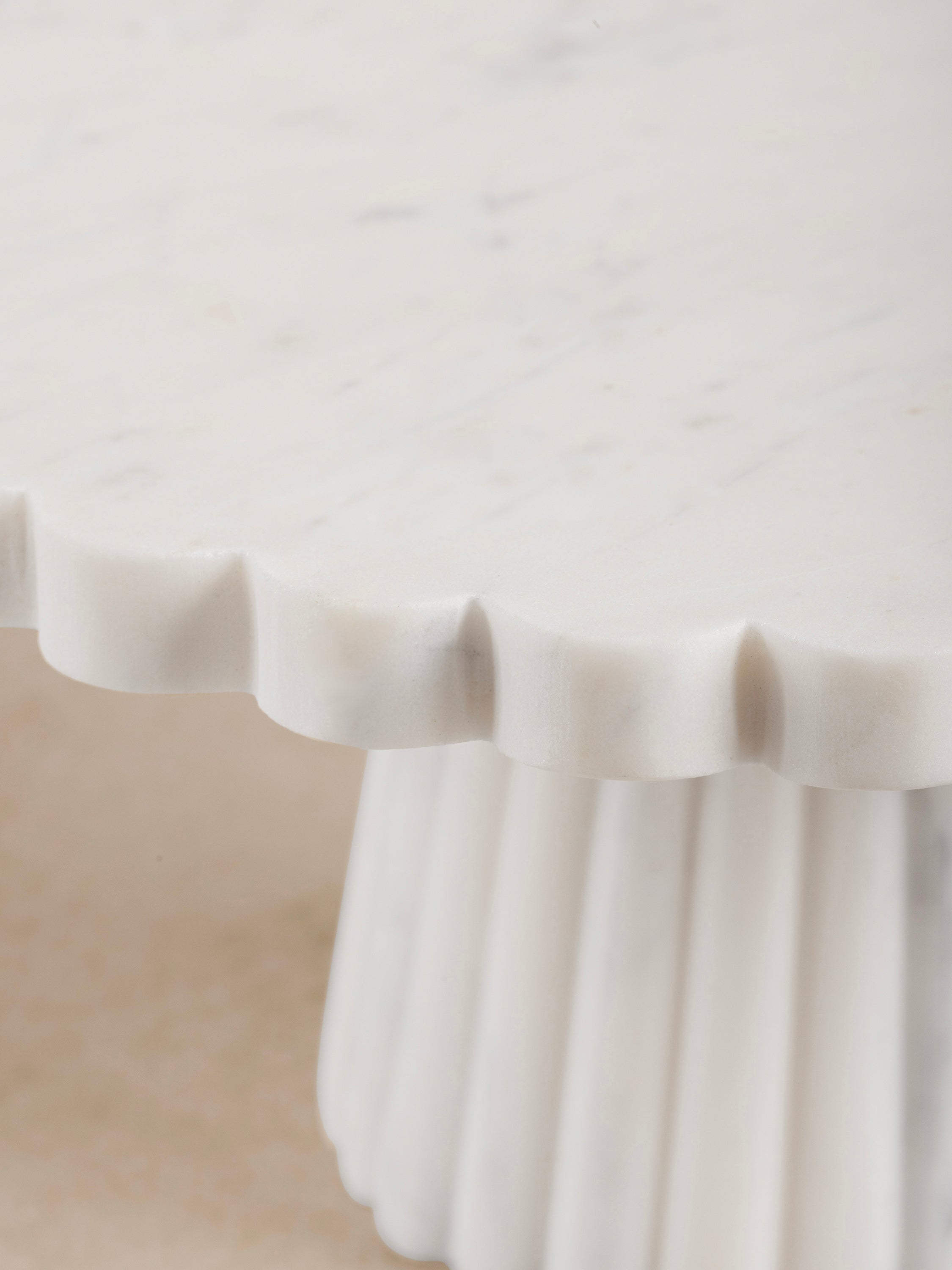 Side profile showing scalloped pedestal base and marble details of Bobby Cake Stand