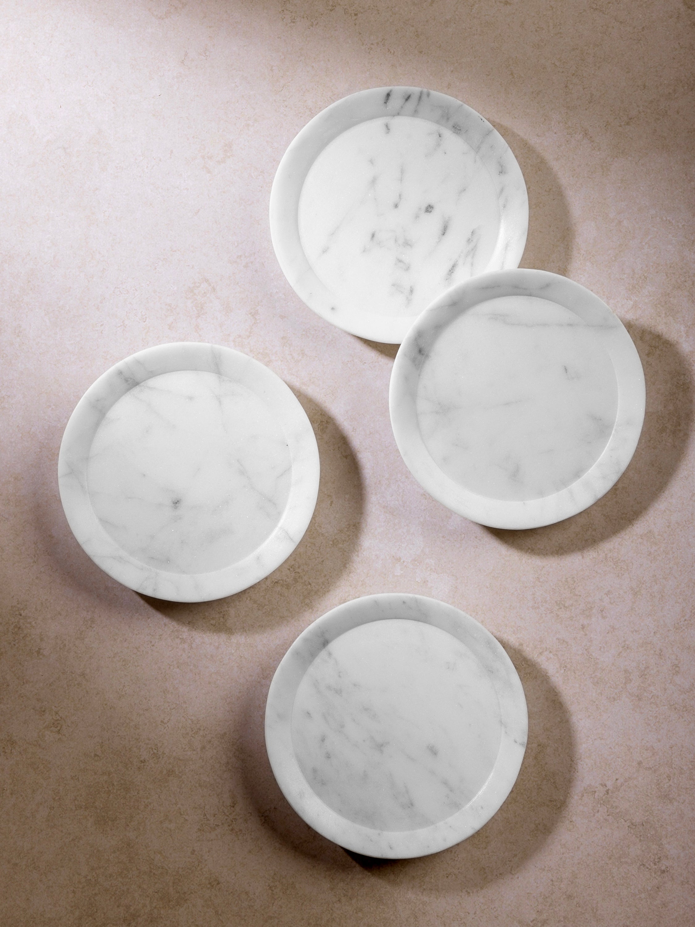 Paloma white marble coasters with purple veining and chiseled design