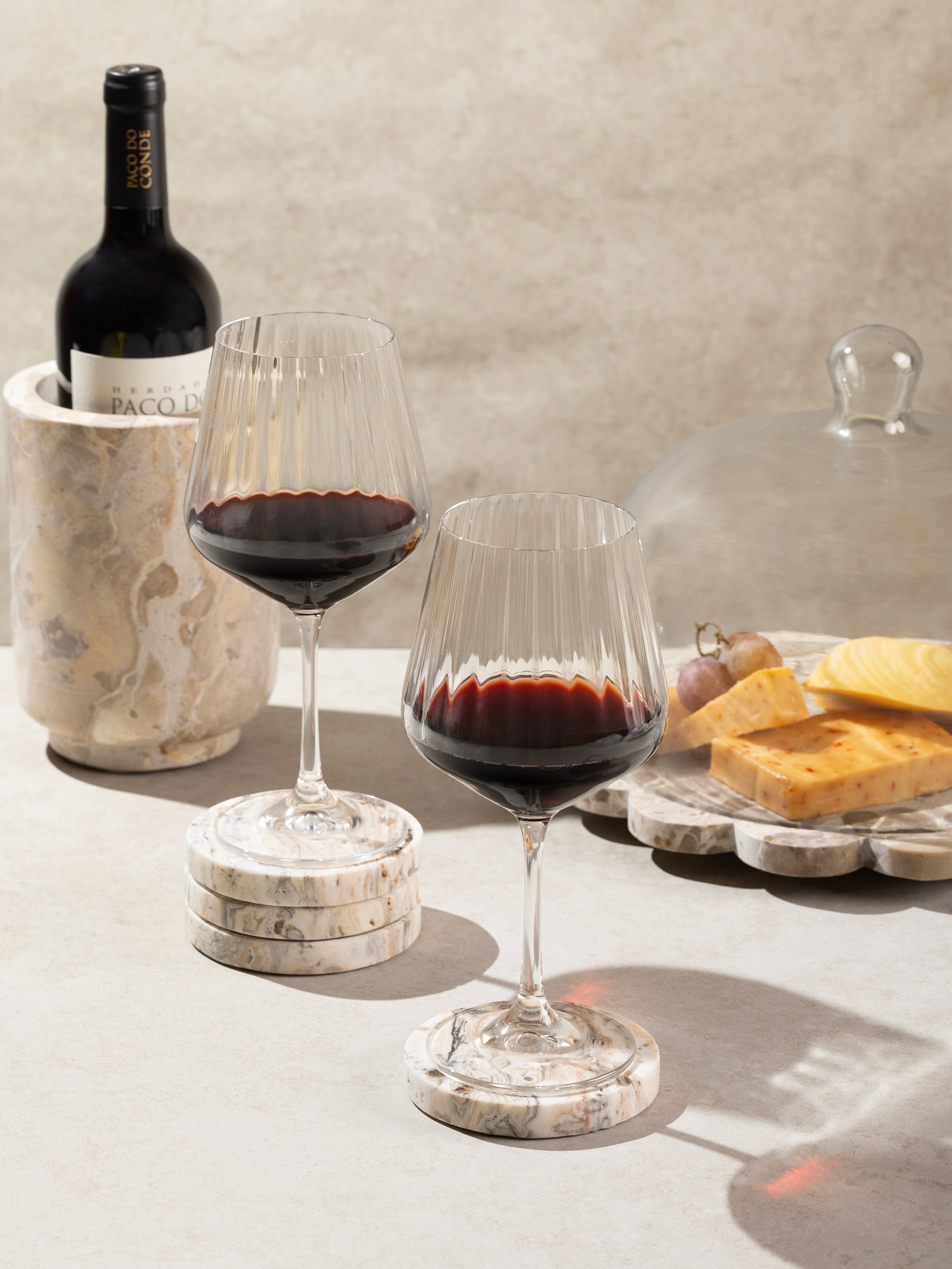 Coasters displayed under wine glasses on a coffee table
