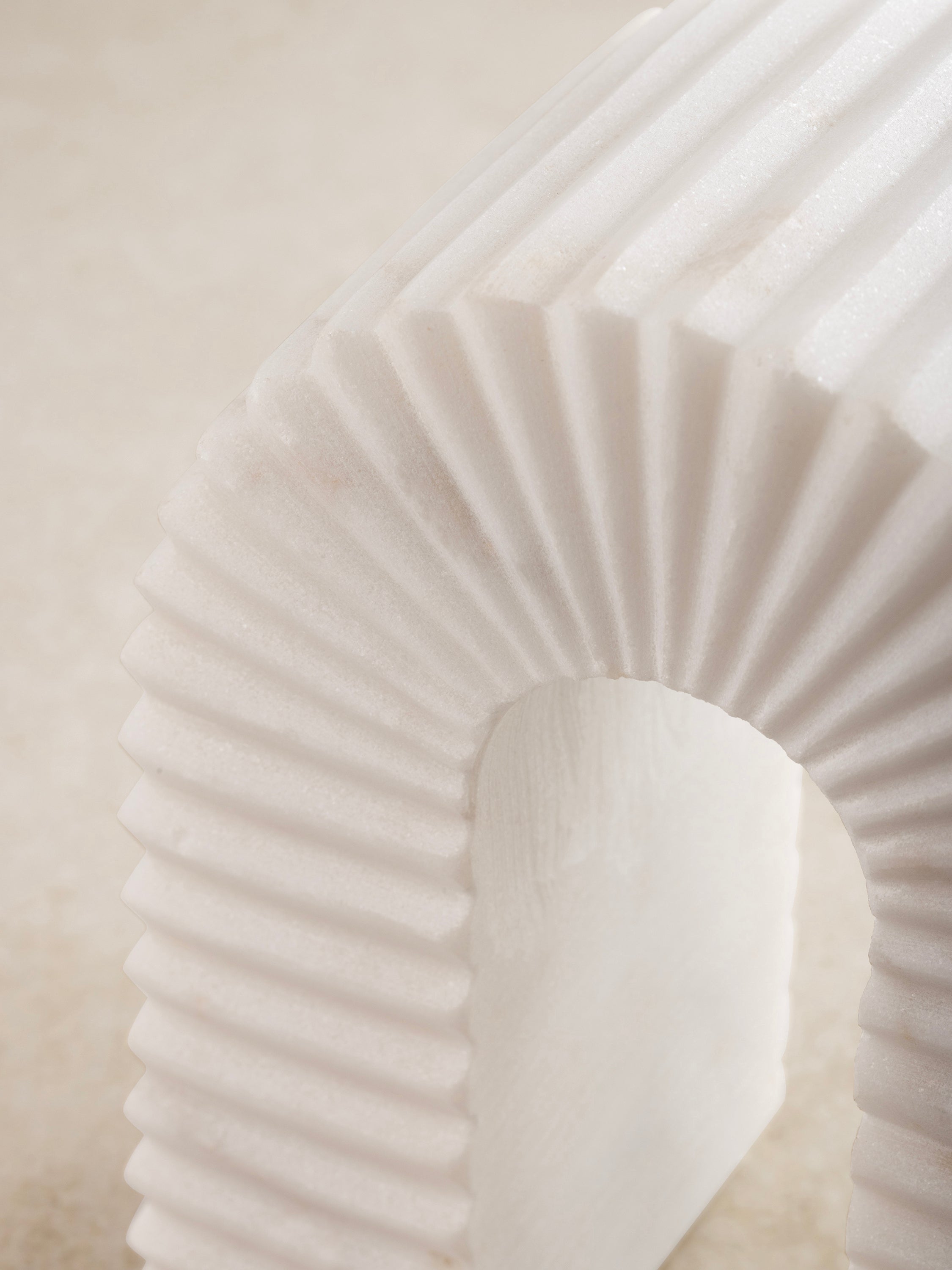 Close-up of ribbed marble surface showing veining and texture