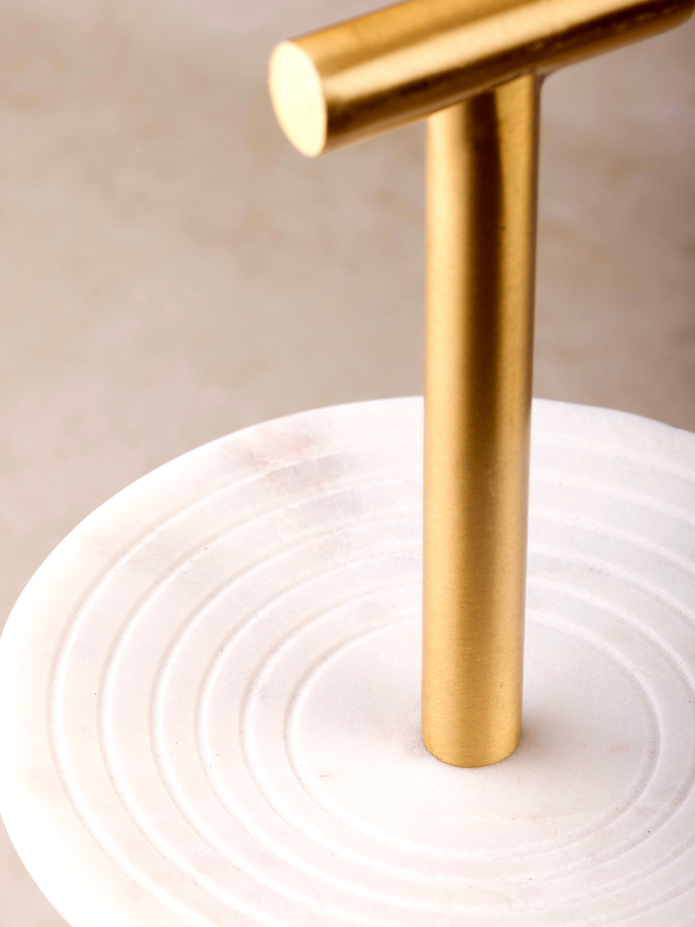 Close-up of grooved marble surface and gold base of Regalia stand