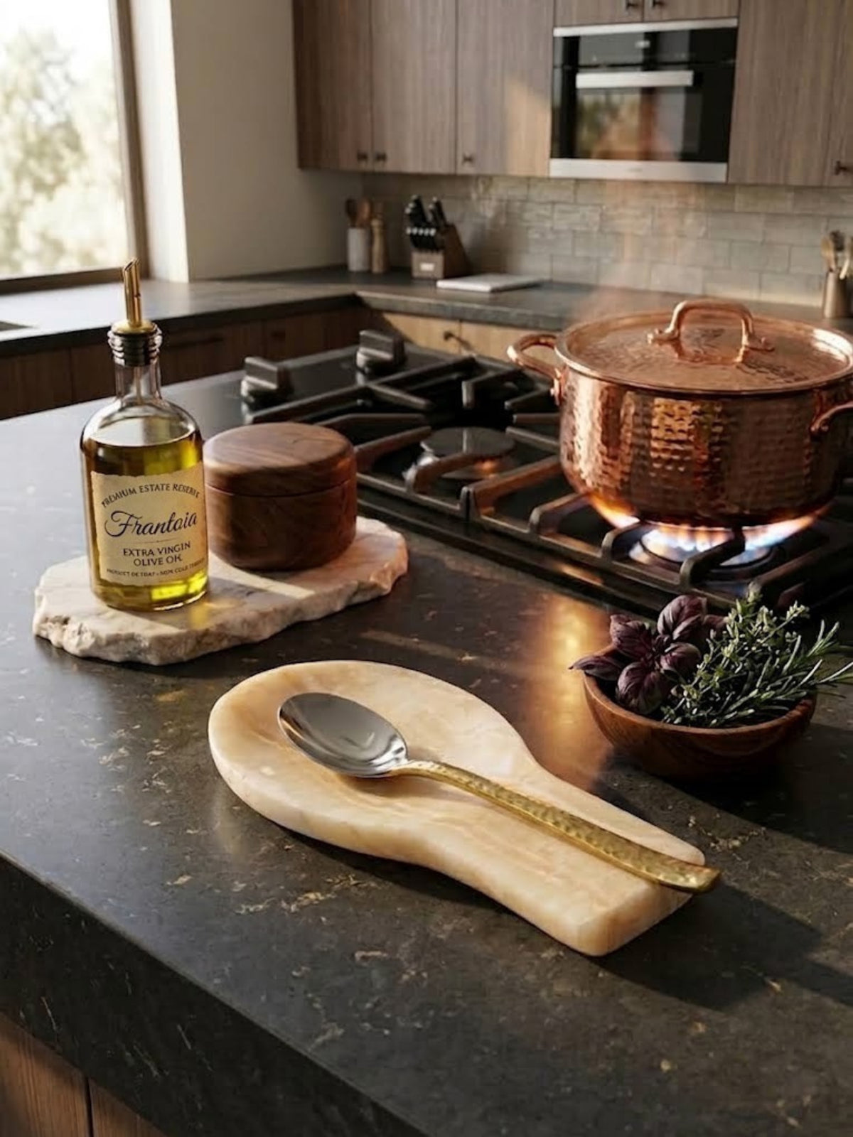 Machu Picchu onyx spoon rest set beside a stove with copper pans, spoon resting in the head.