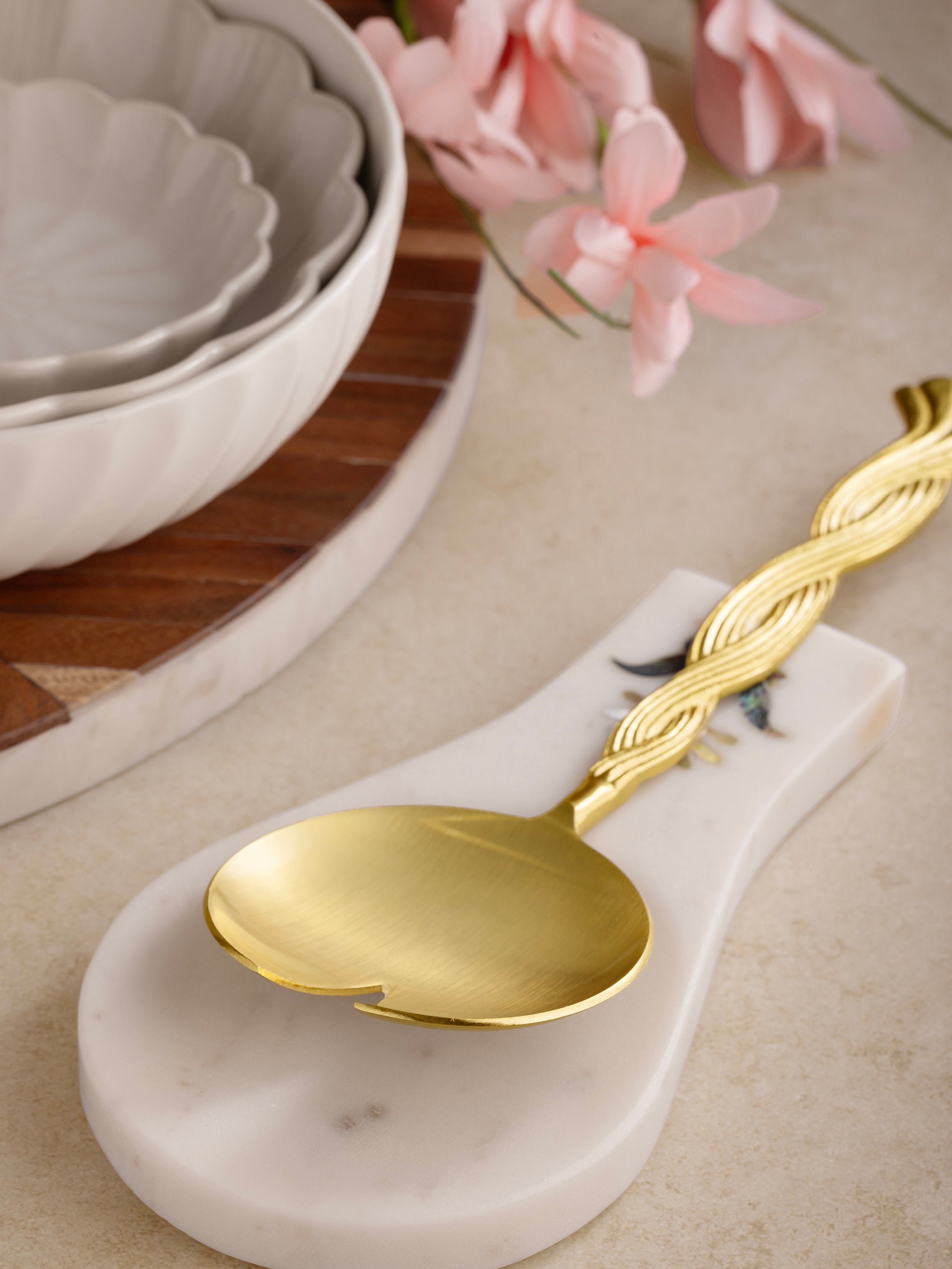 Spoon rest styled on a kitchen counter with utensils nearby