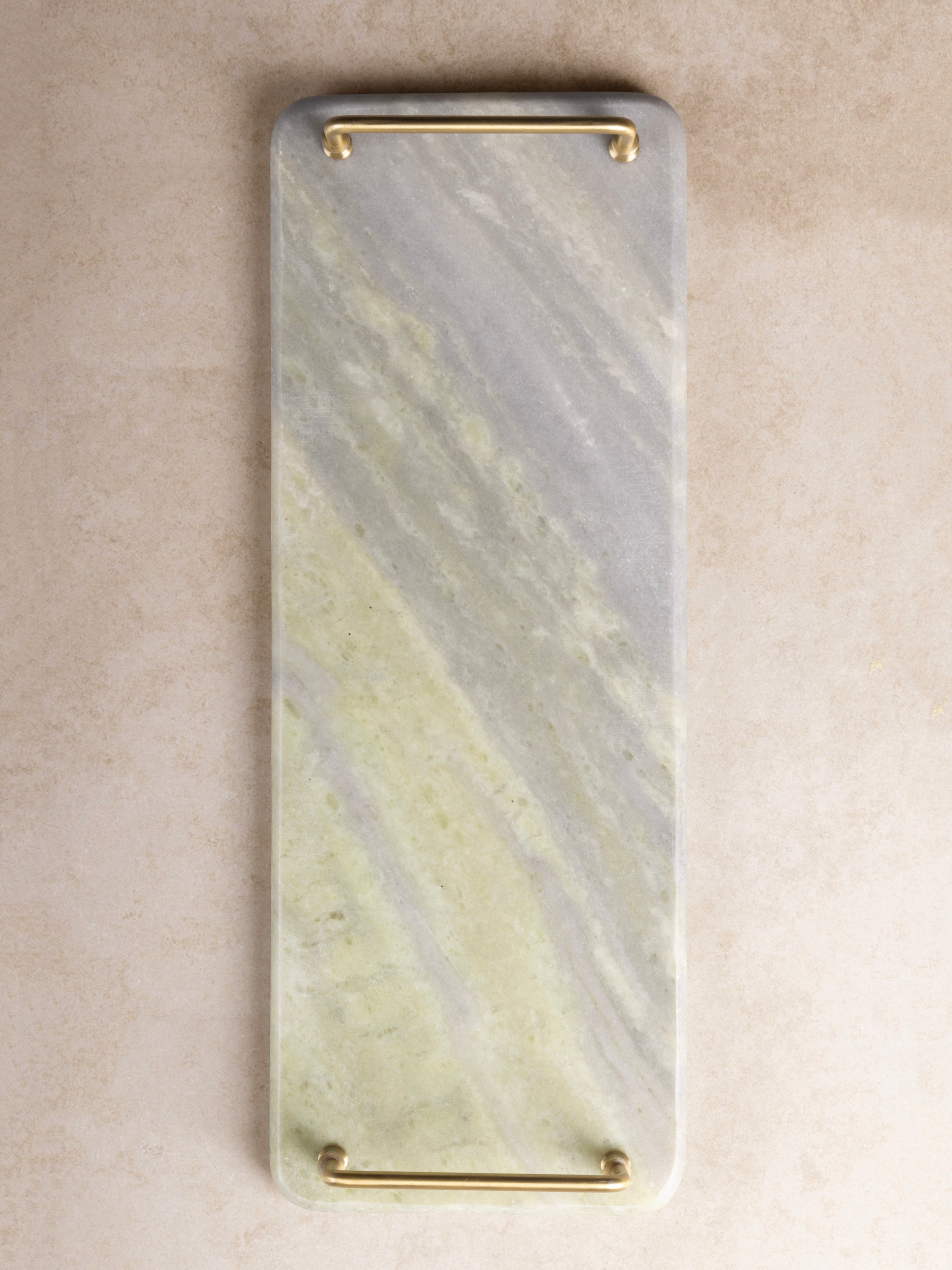 Rectangular green onyx tray with rounded edges and brass handles, shown in a clean top-down view highlighting natural stone patterning