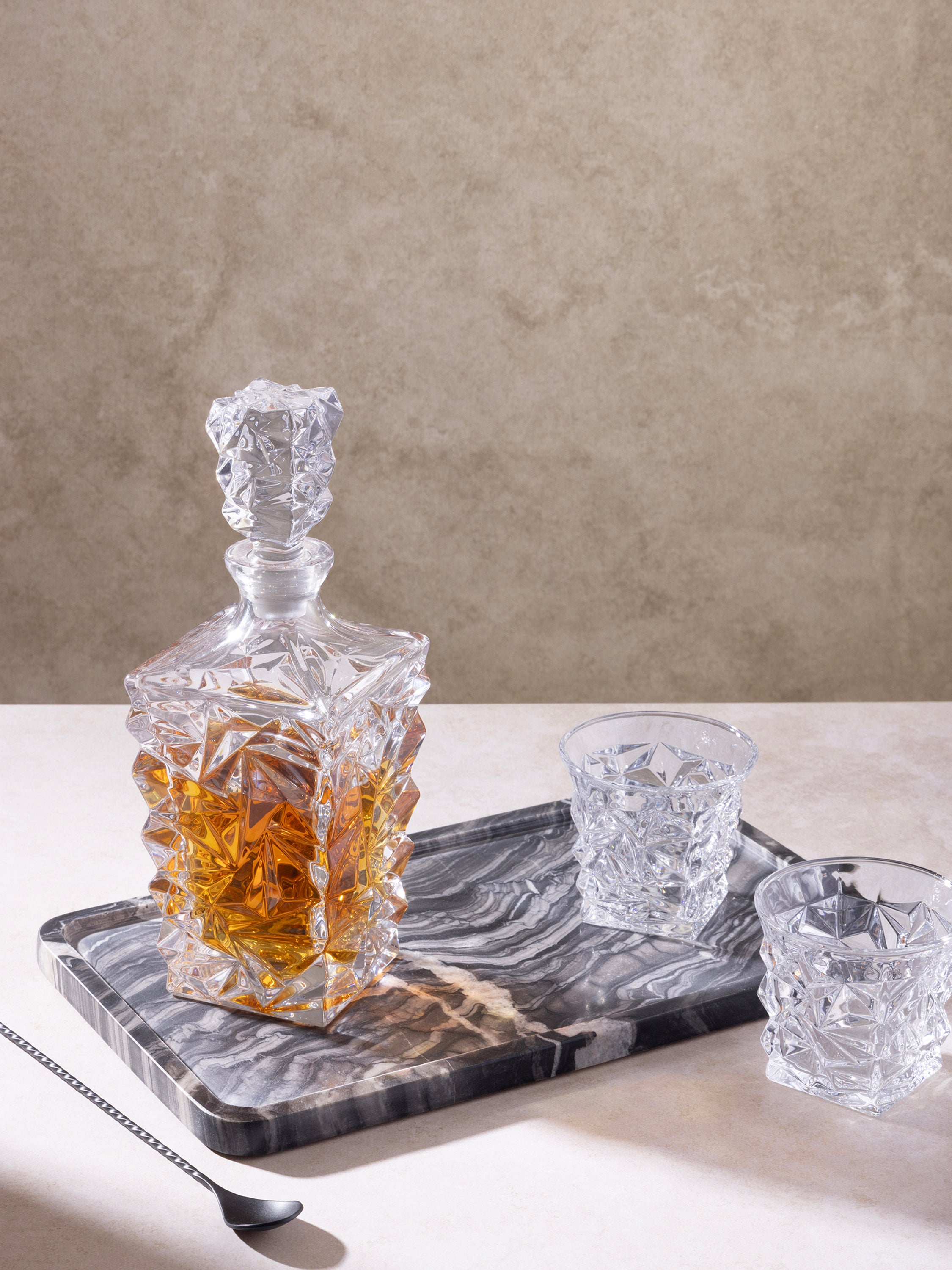 Frontier Tray styled with decorative items on a console in moody décor