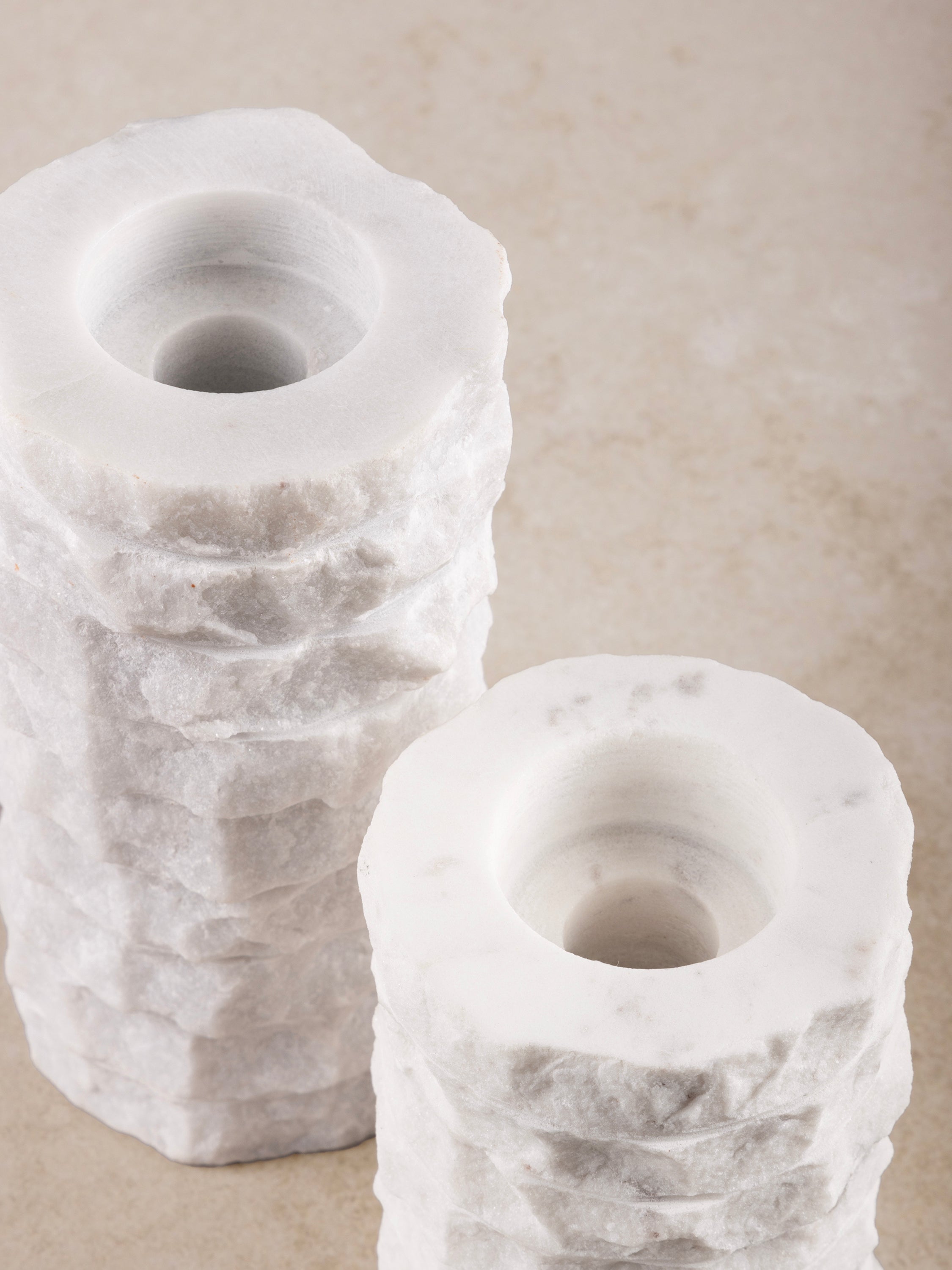 Close-up of chiseled marble texture on Flores candle holder set