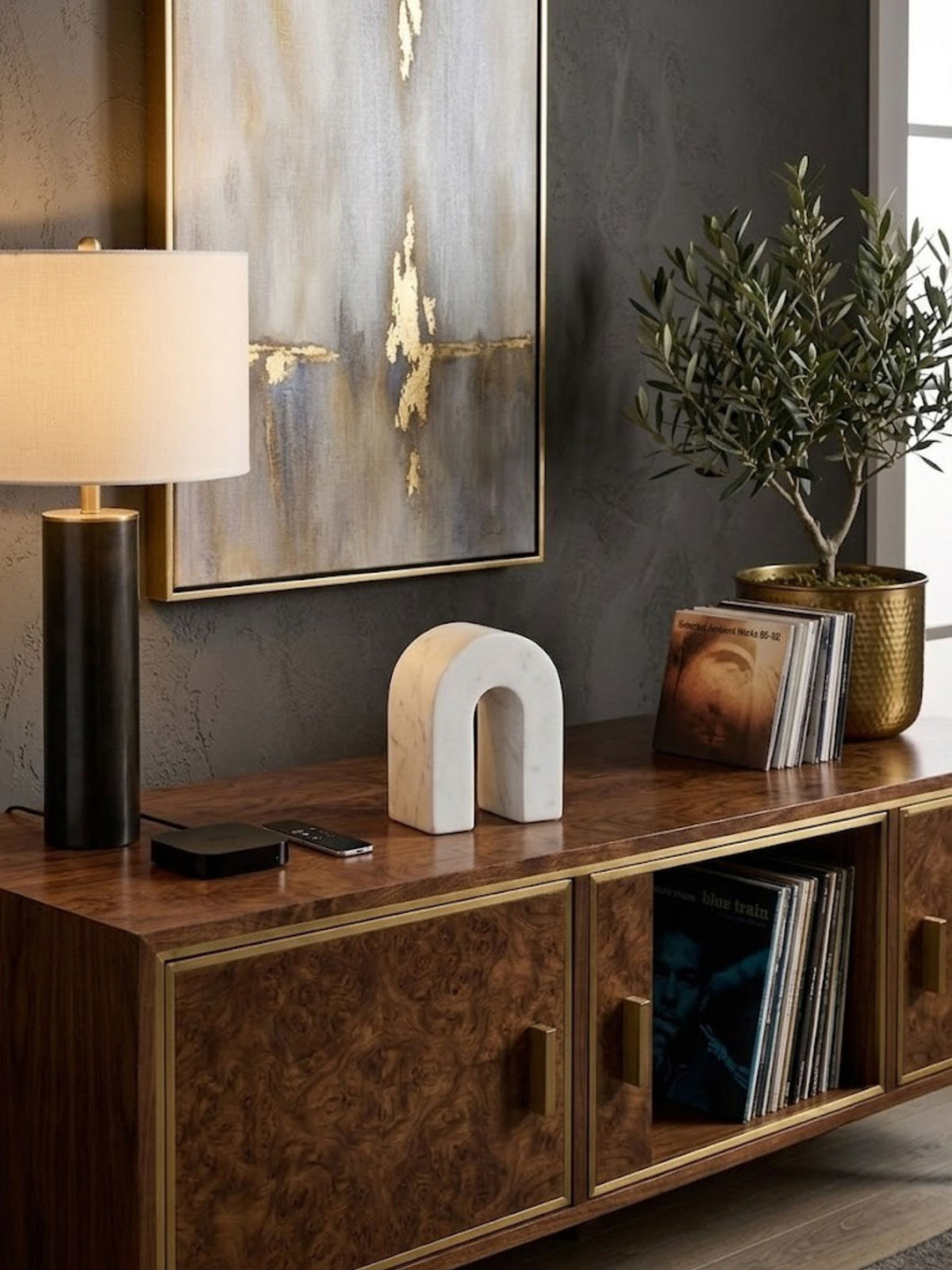 Matte white marble arch object, styled on a living room credenza.