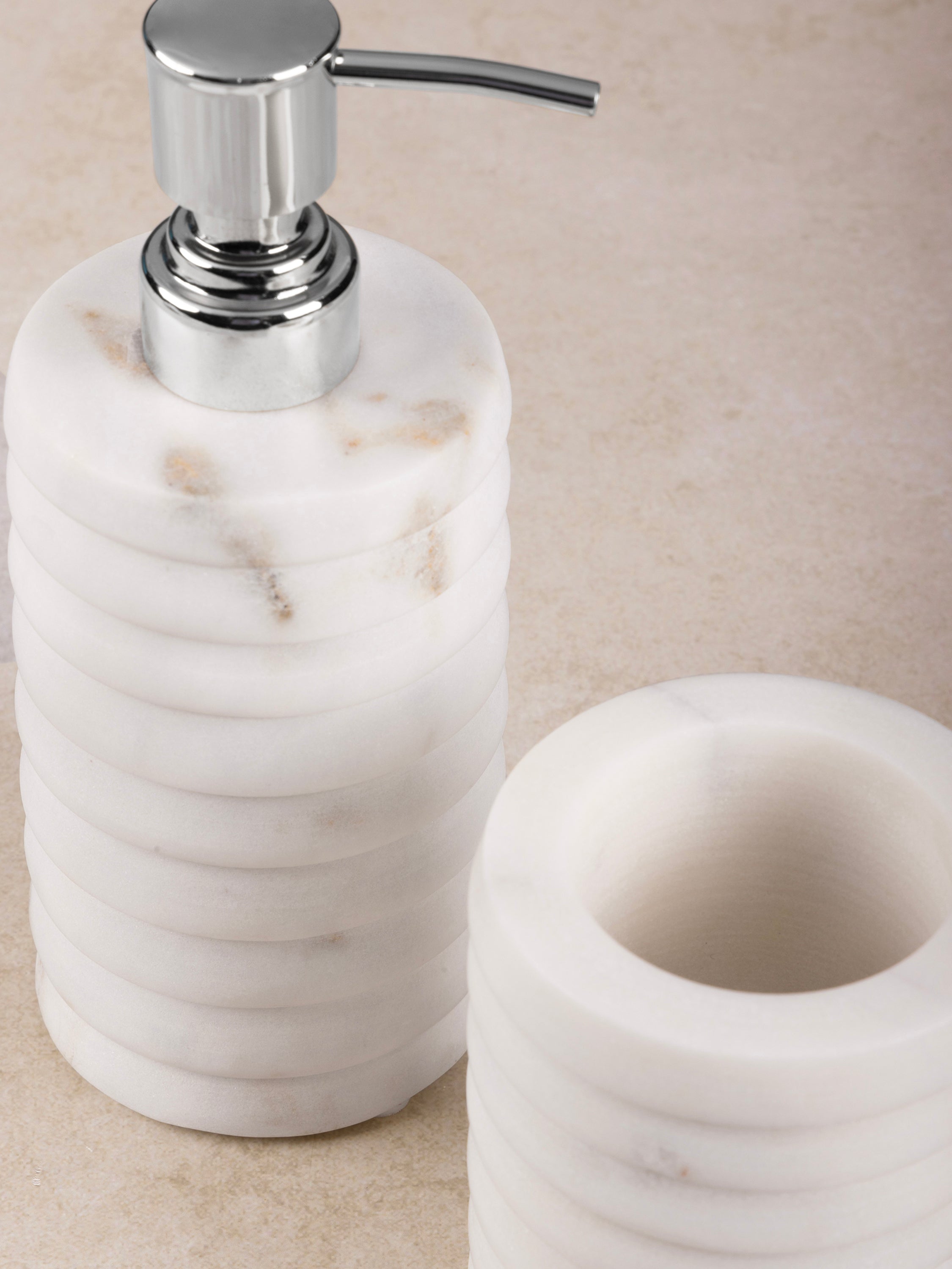 Close-up of ribbed white marble texture on Raavi lotion dispenser