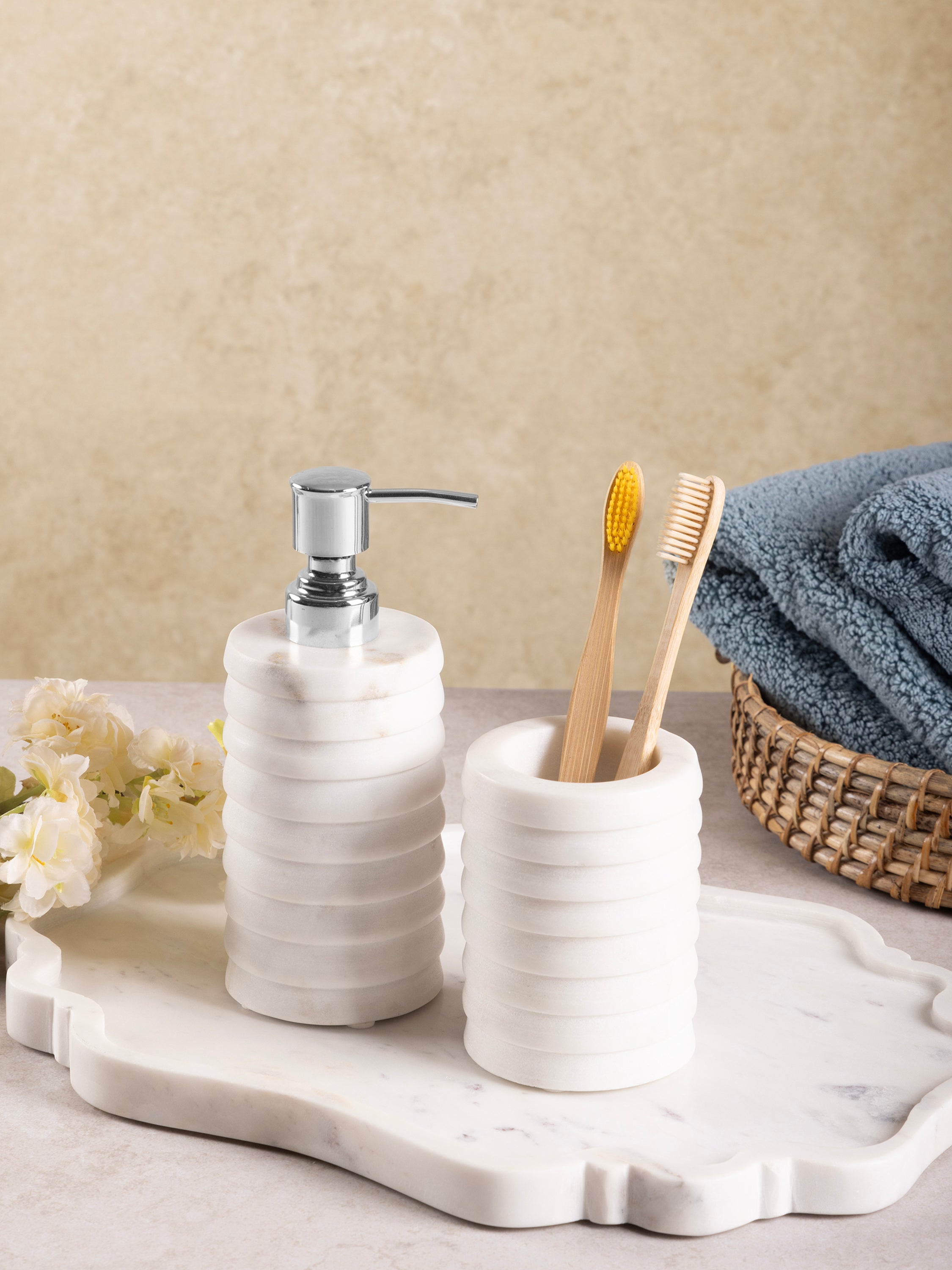 Raavi set styled with white towels and metal accents in bathroom décor