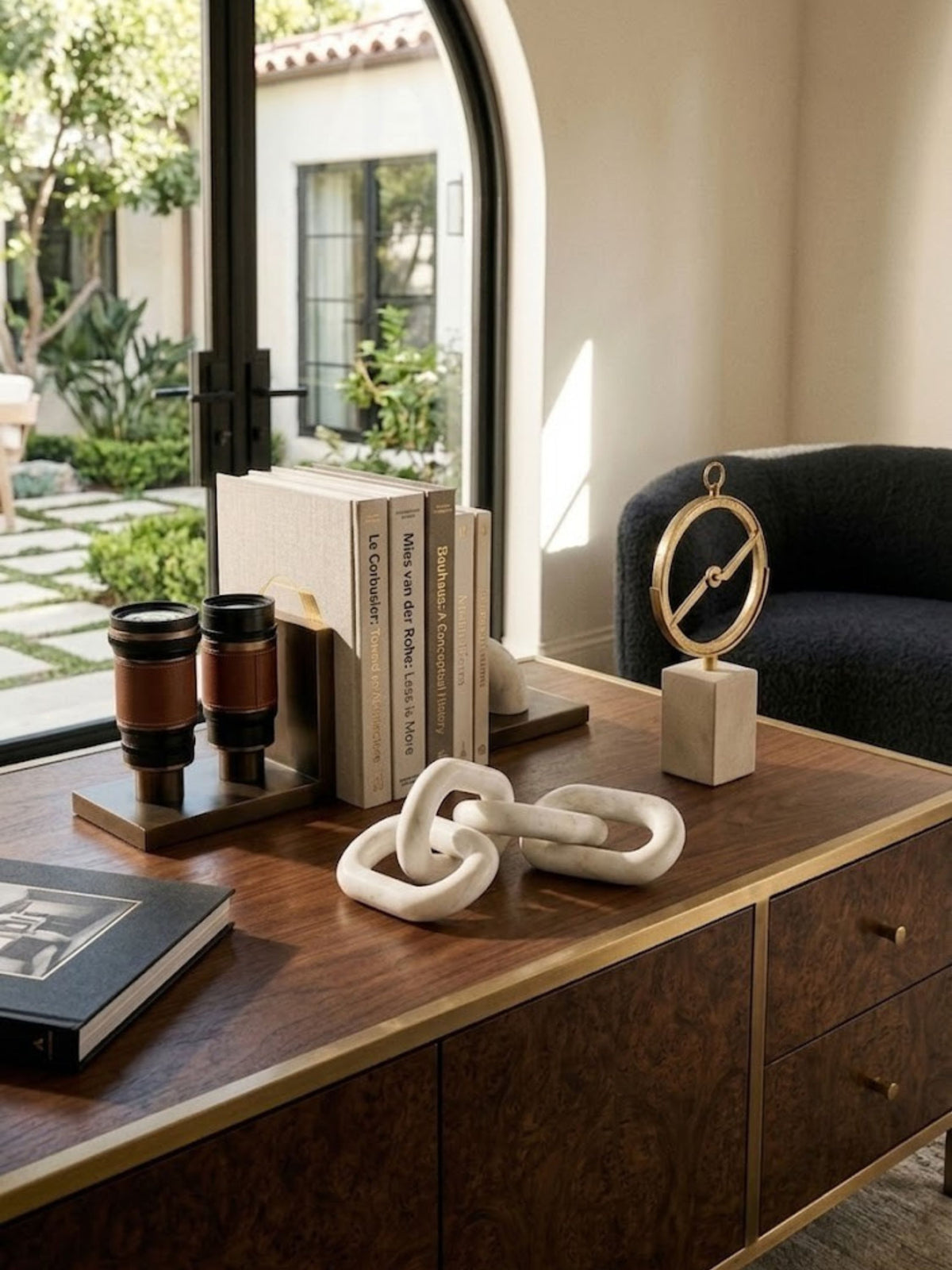 White marble chain-link sculpture displayed on a home office credenza.