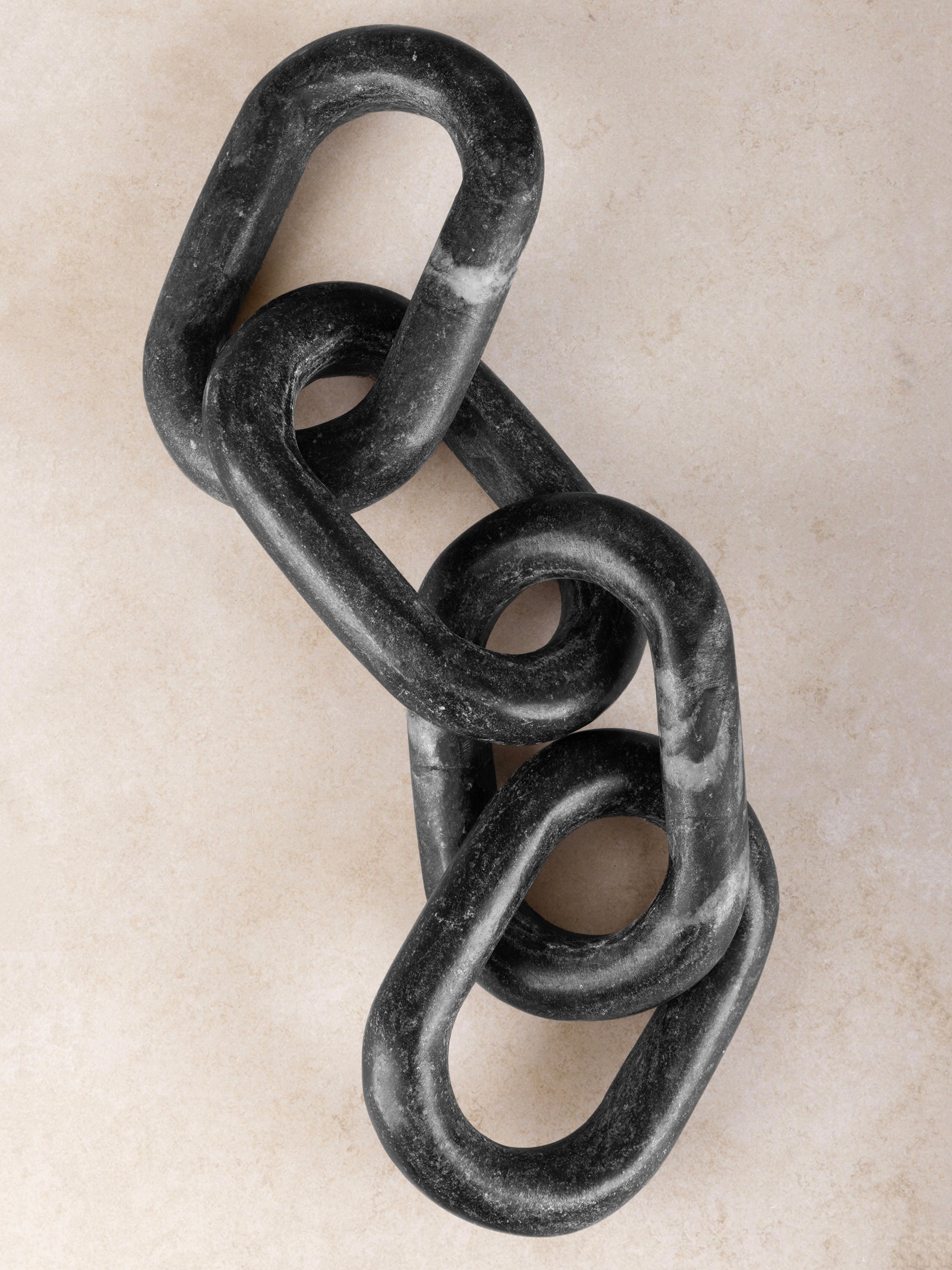 Black marble chain links detail showing natural veining and polish