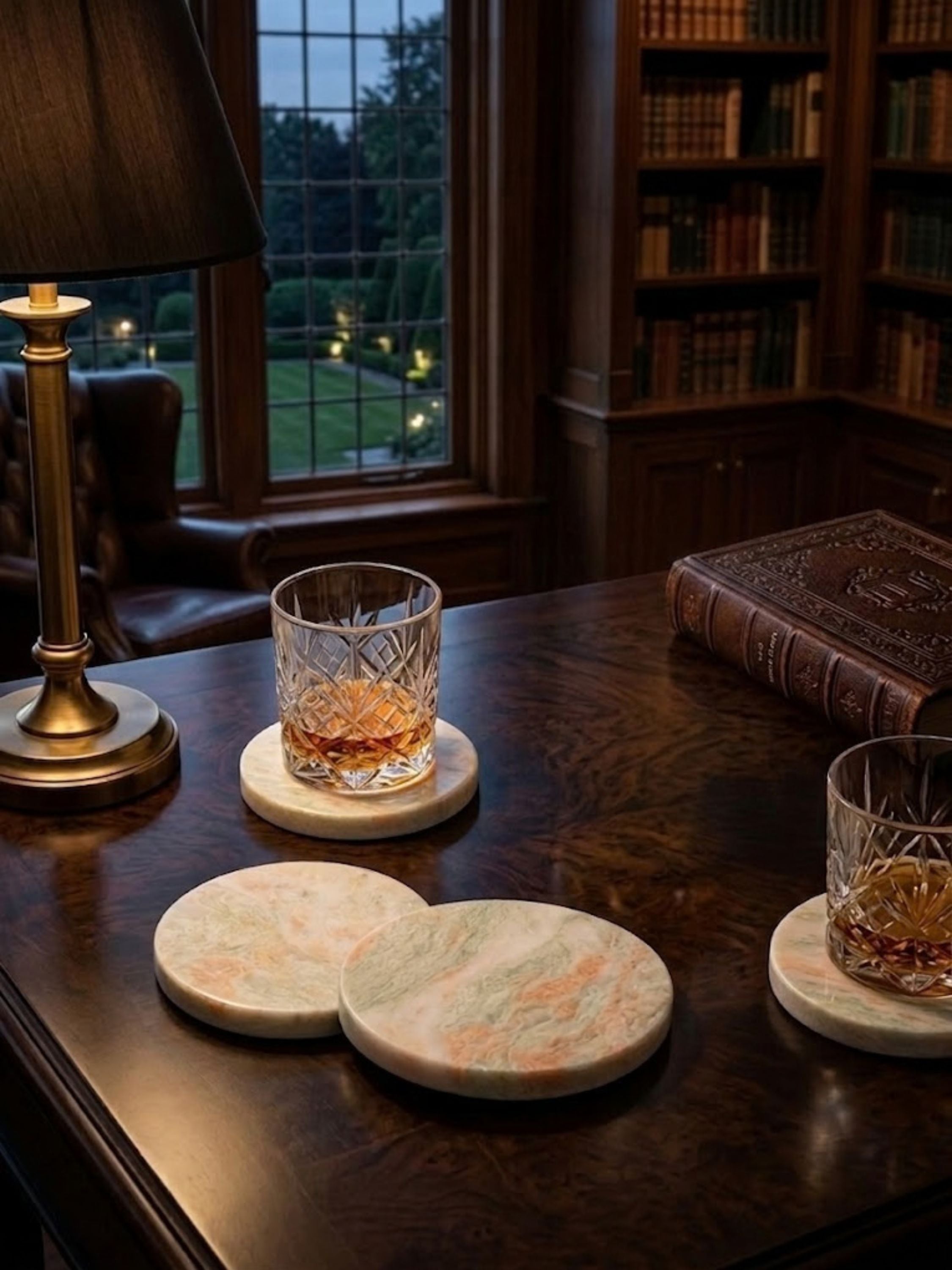 Moonlight onyx coasters styled in a library-inspired whiskey setting, showcasing soft green veining and refined stone character.