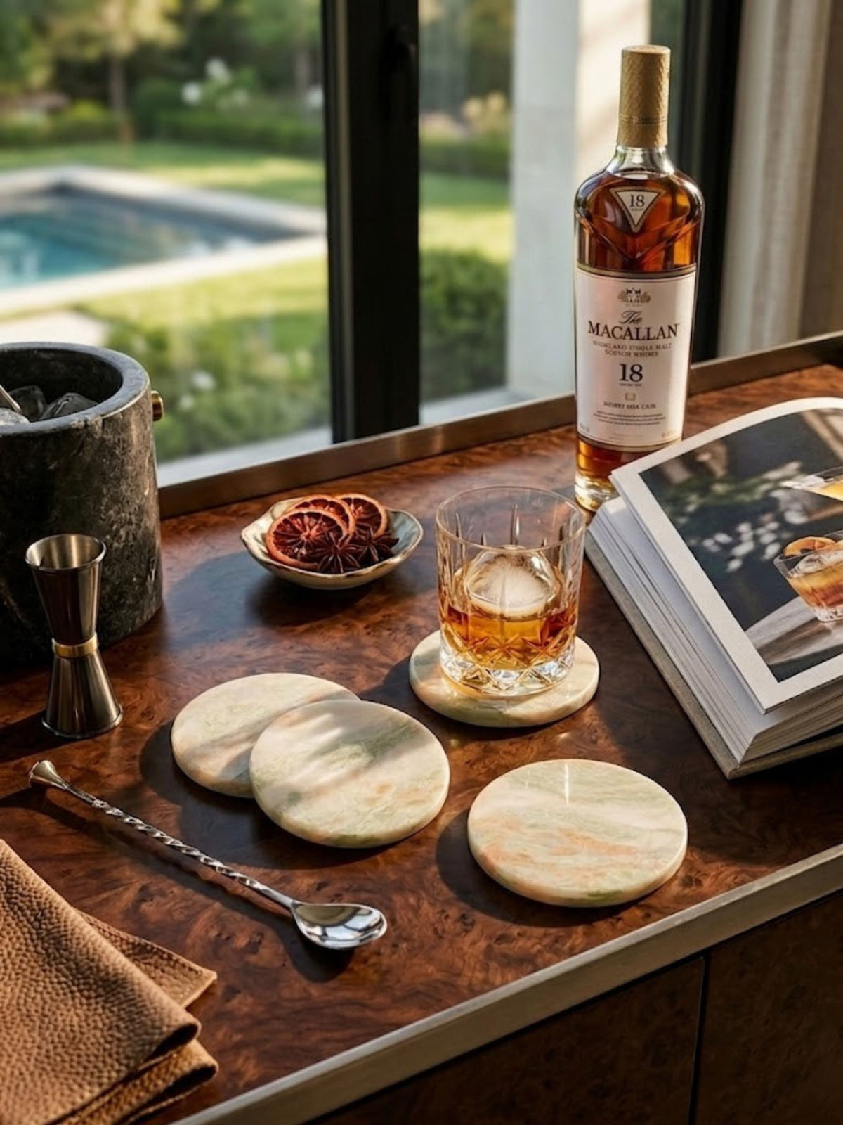 Onyx coaster set of four styled on a bar cart, sage-green veining visible across each coaster.