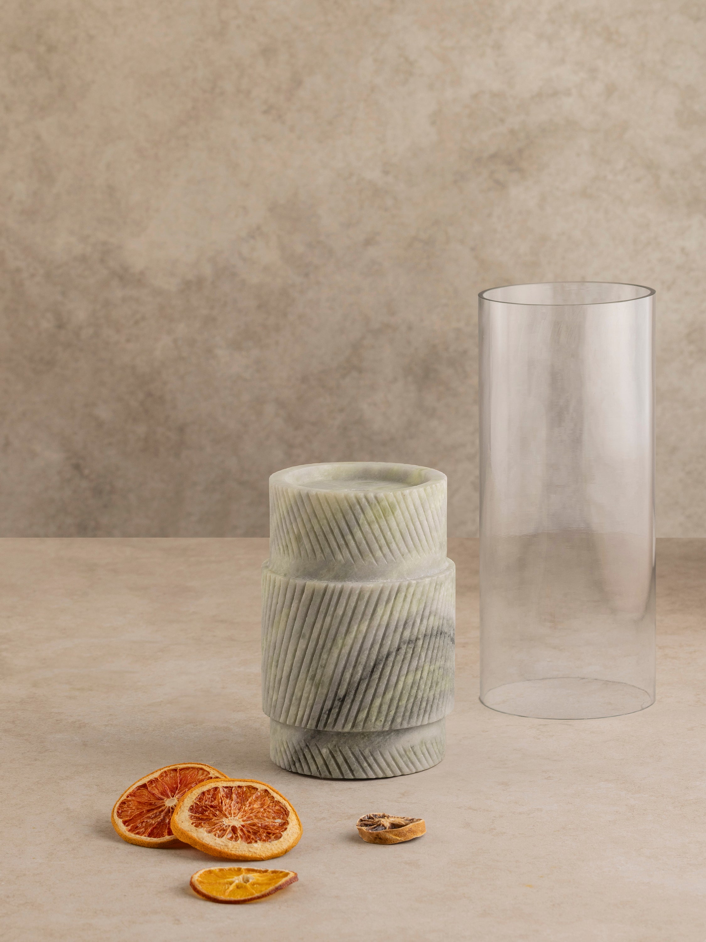 Set of two Estonia green onyx hurricane candle holders shown together, highlighting sculptural stone bases and cylindrical glass inserts