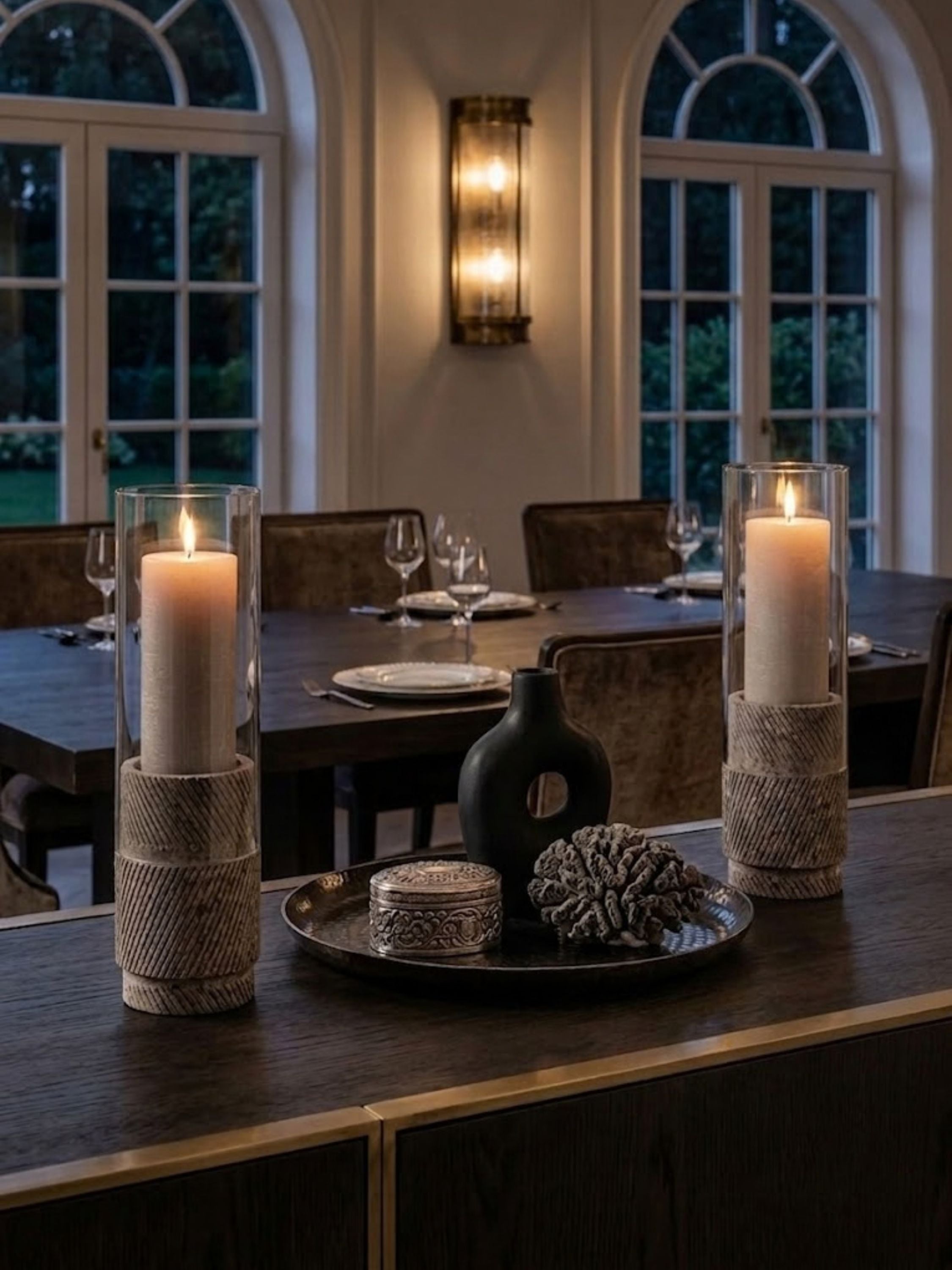 Estonia Brown Travertine hurricane candle holders styled on a dining room sideboard, introducing understated warmth and refined ambiance for elegant gatherings.