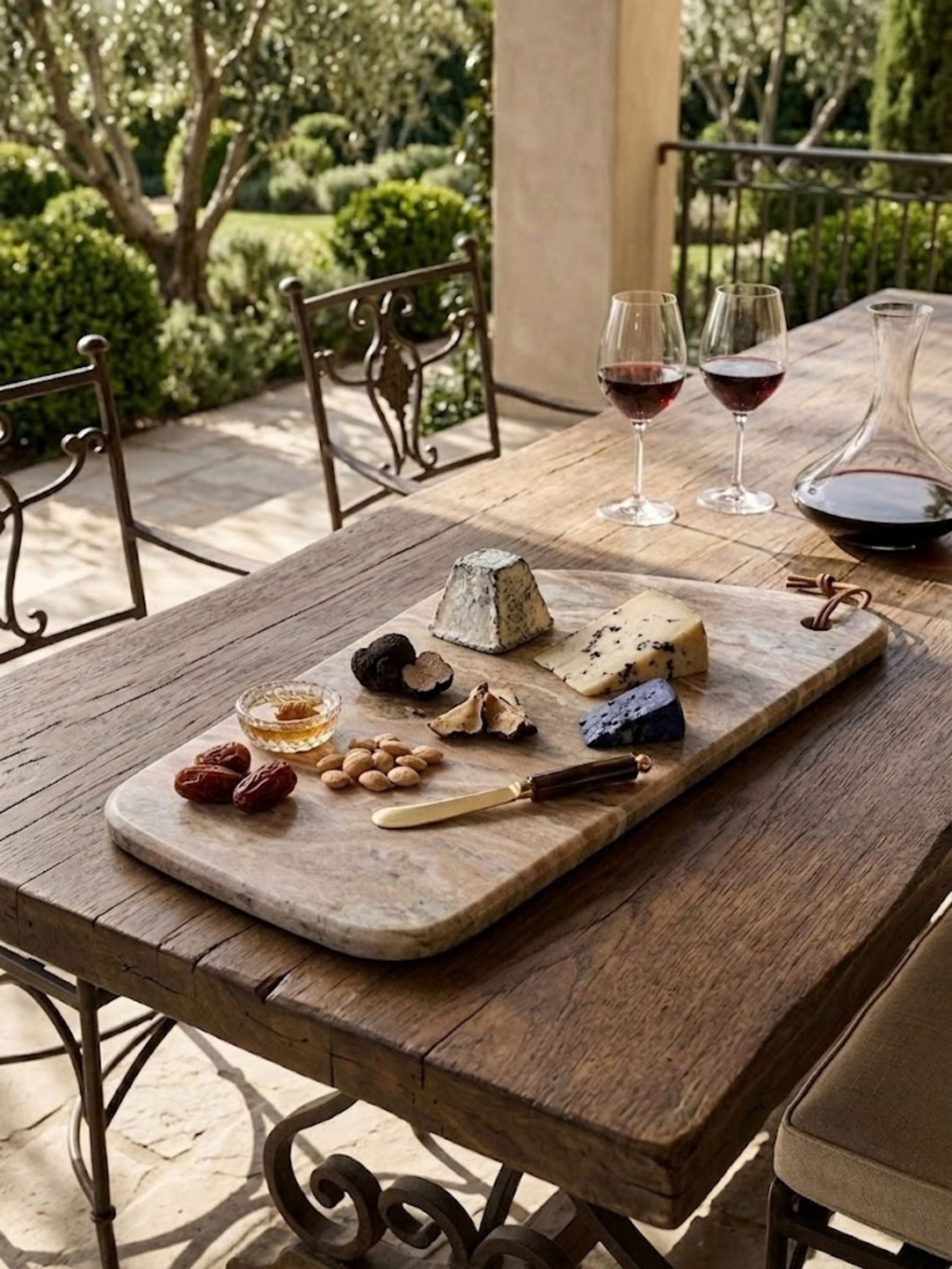 Dakota Marble cheese board styled for outdoor wine and cheese entertaining, showcasing natural stone character with artisan cheeses, wine service, and relaxed terrace dining.