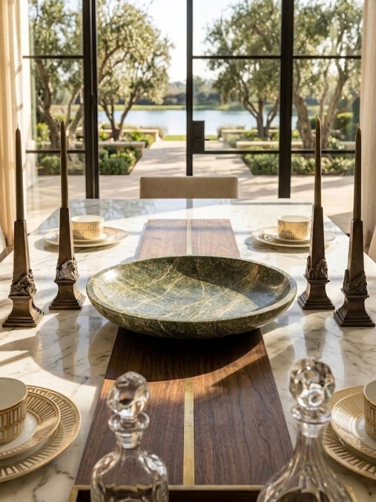 Green marble bowl with branching veining, styled on a dining table.