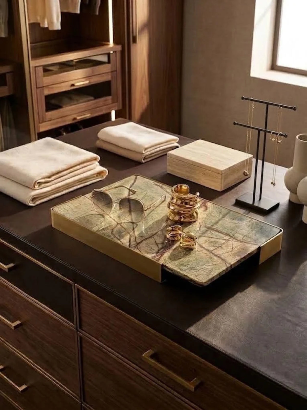 Normandy onyx marble tray holding sunglasses and rings on a dressing table.