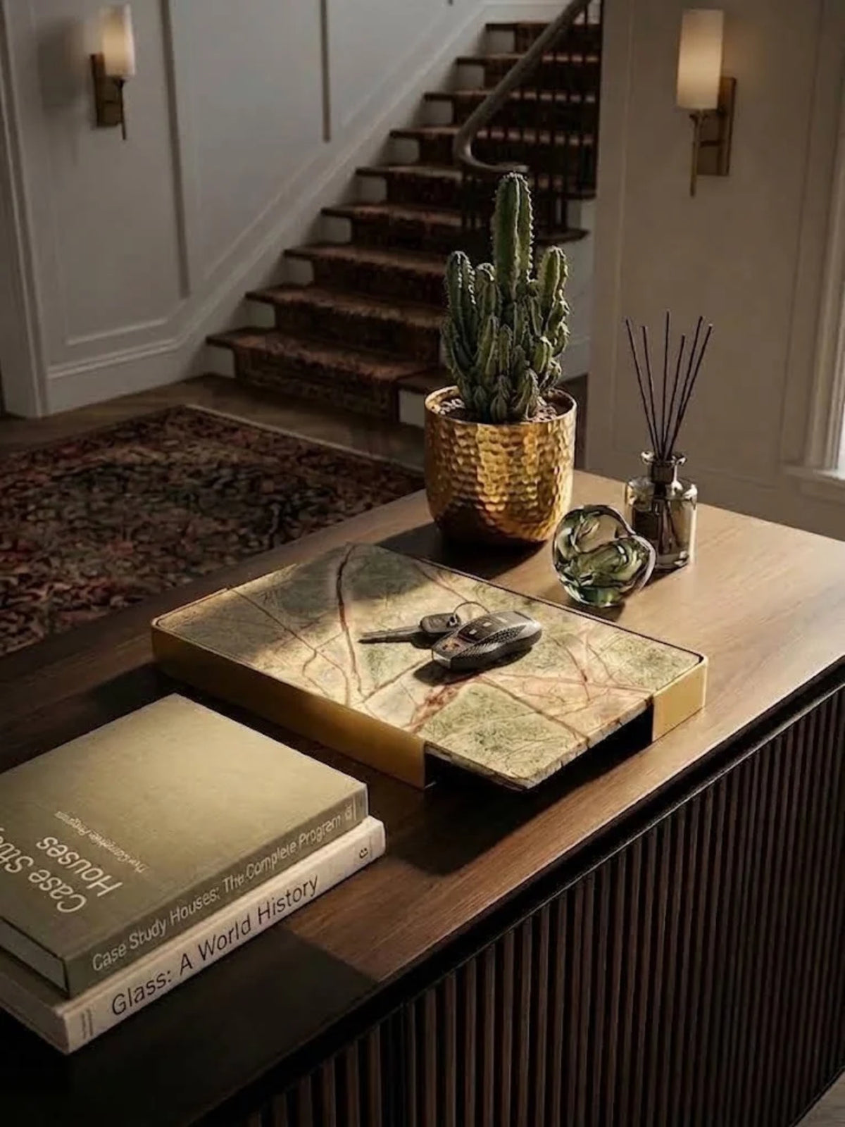 Normandy onyx marble tray holding a reed diffuser on an entryway console.