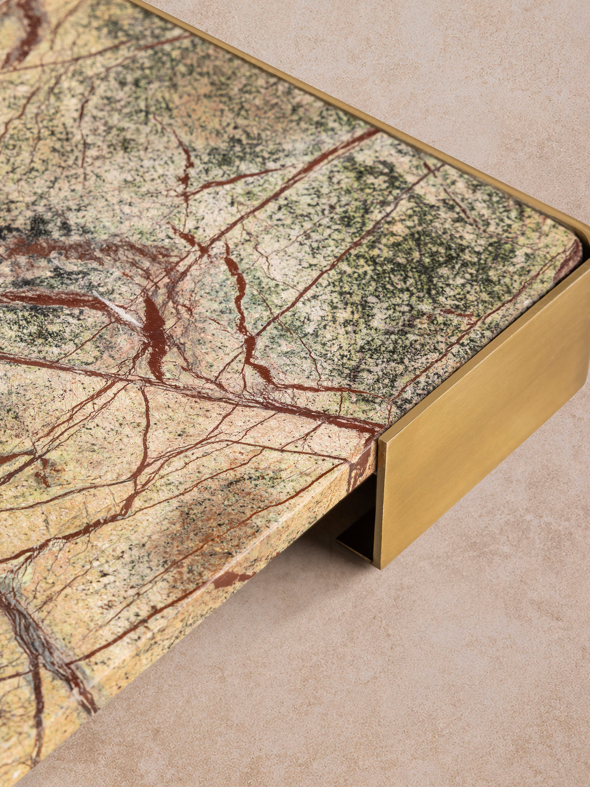 Normandy onyx marble tray, russet veins branching across moss green stone, brushed gold handle at the end.