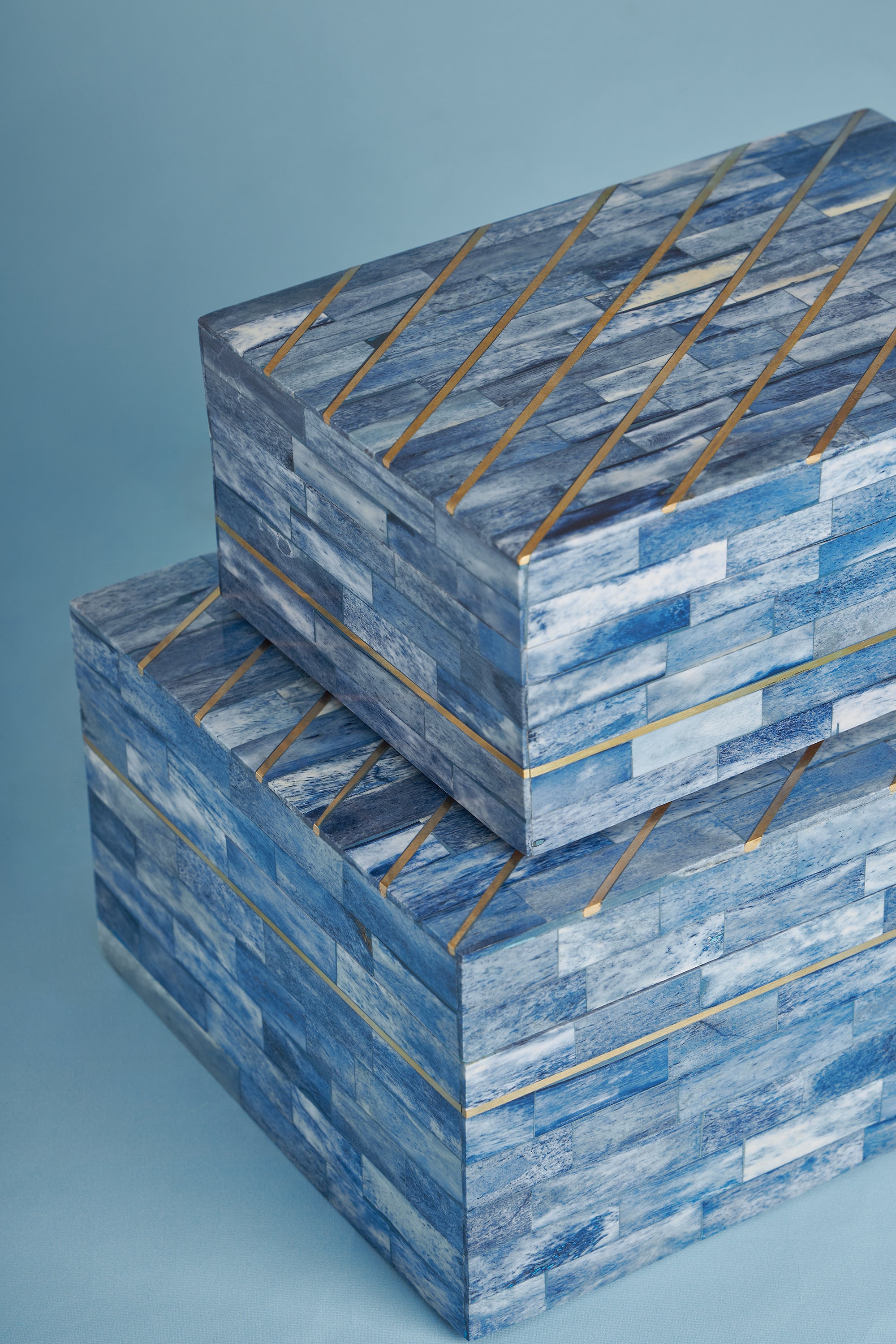 Set of two blue bone storage boxes with polished finish and gold detailing — refined coastal décor pieces