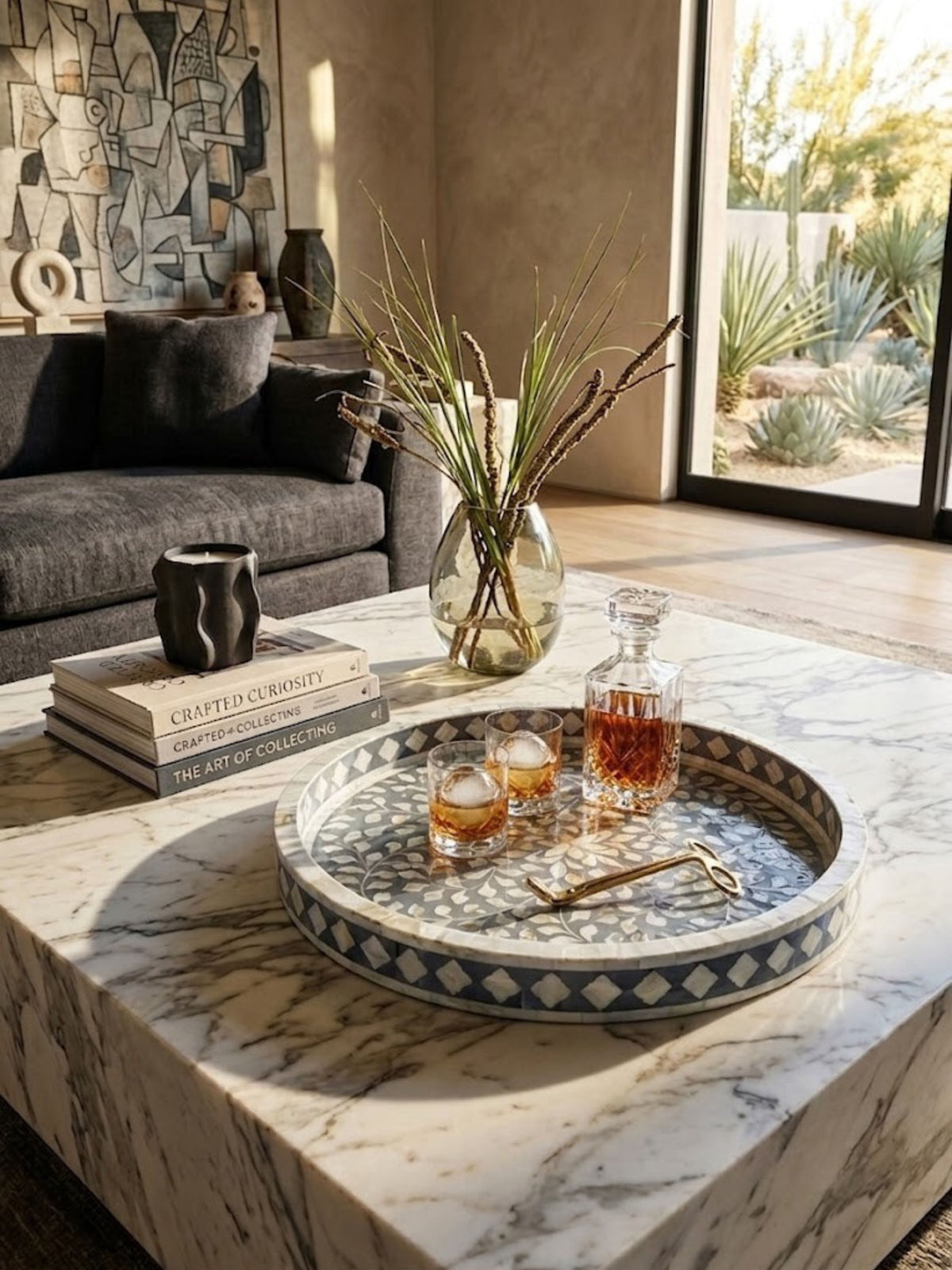 Mother of pearl inlay round tray with an iridescent shell surface, styled on a living room bar.