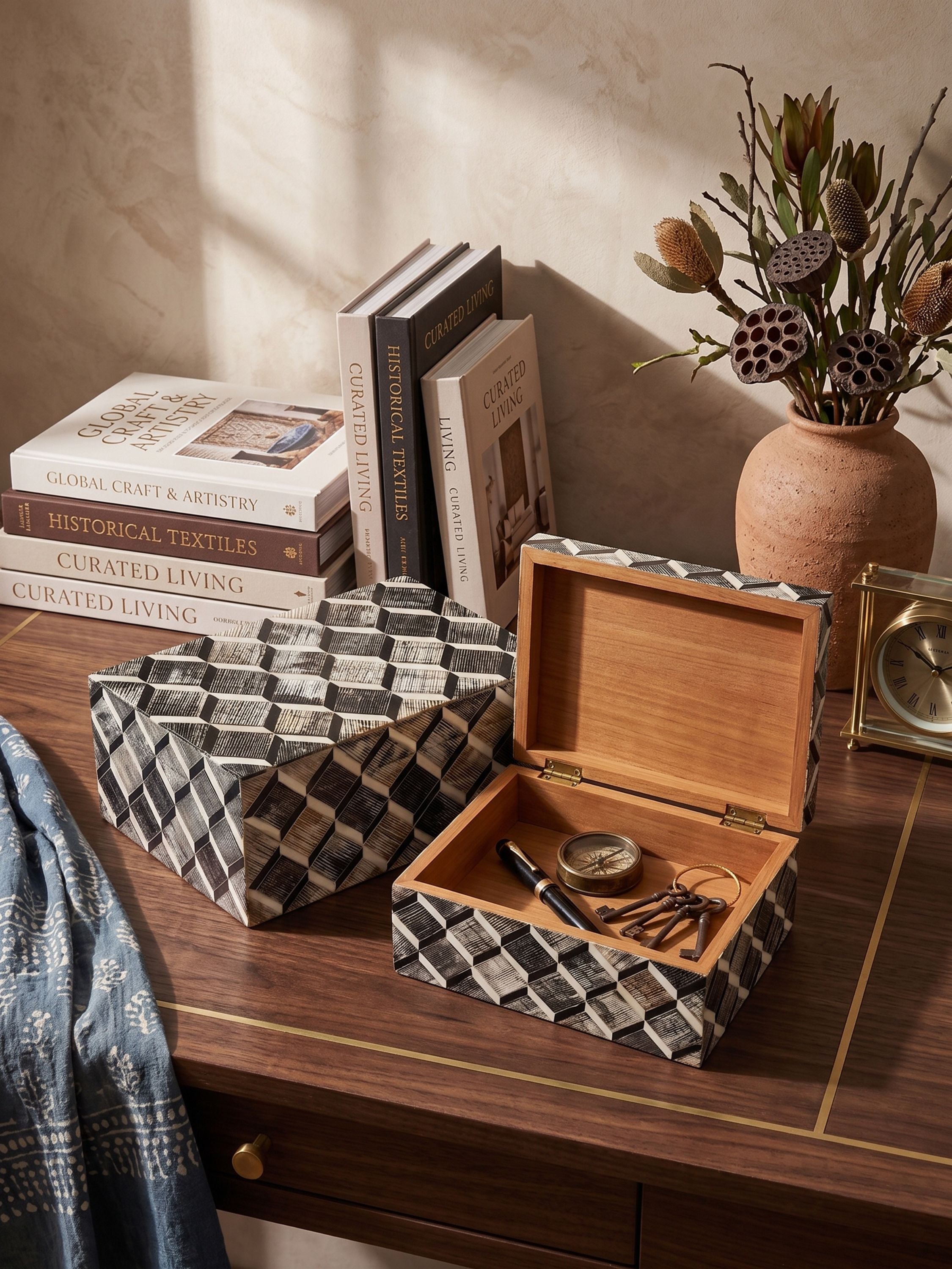 Bone and horn inlay geometric keepsake boxes set of two styled open and closed on a wooden table with books and decorative objects