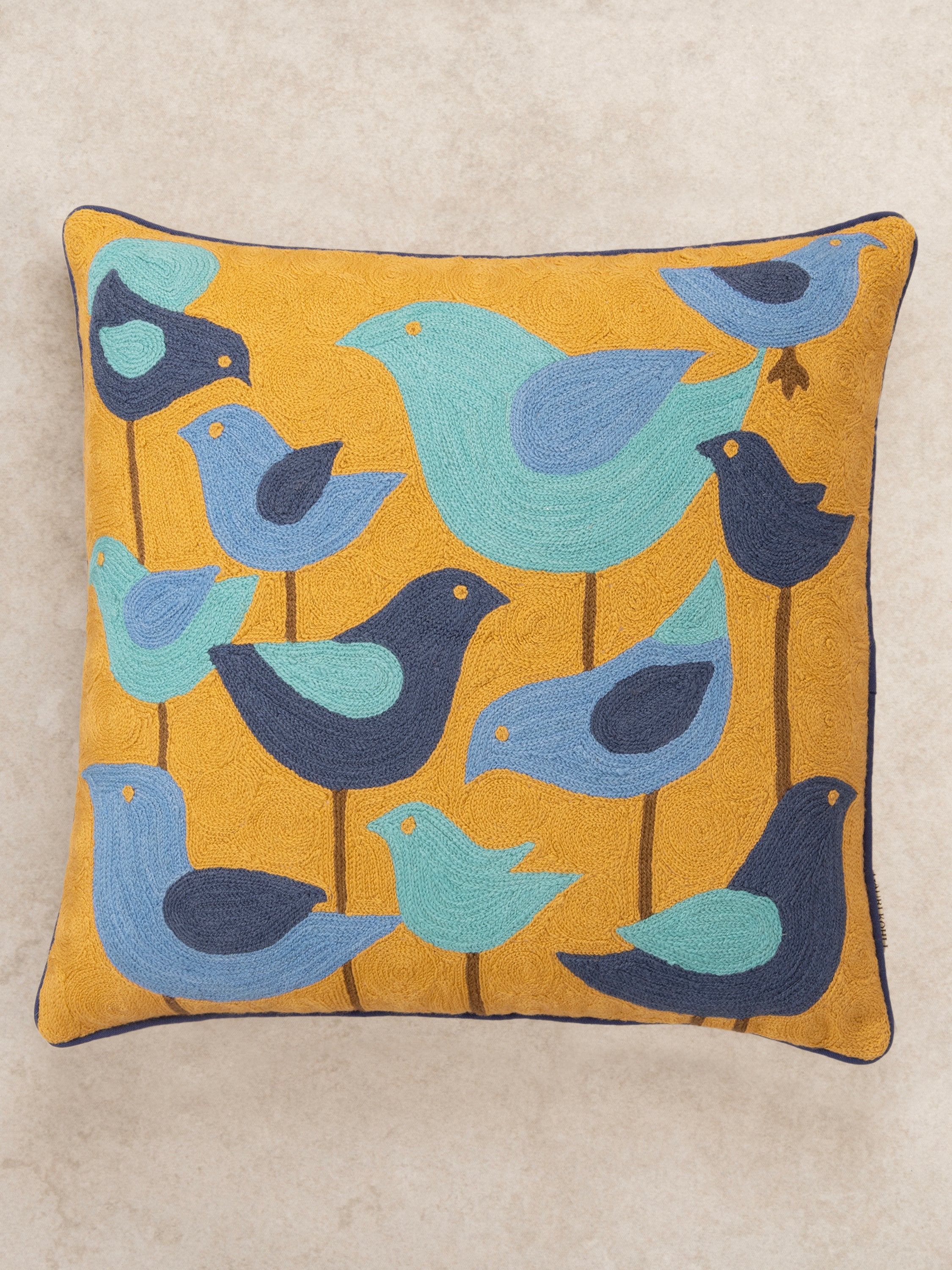 Modern decorative cushion with a playful bird pattern, crafted with intricate embroidery for a stylish and artistic home accent