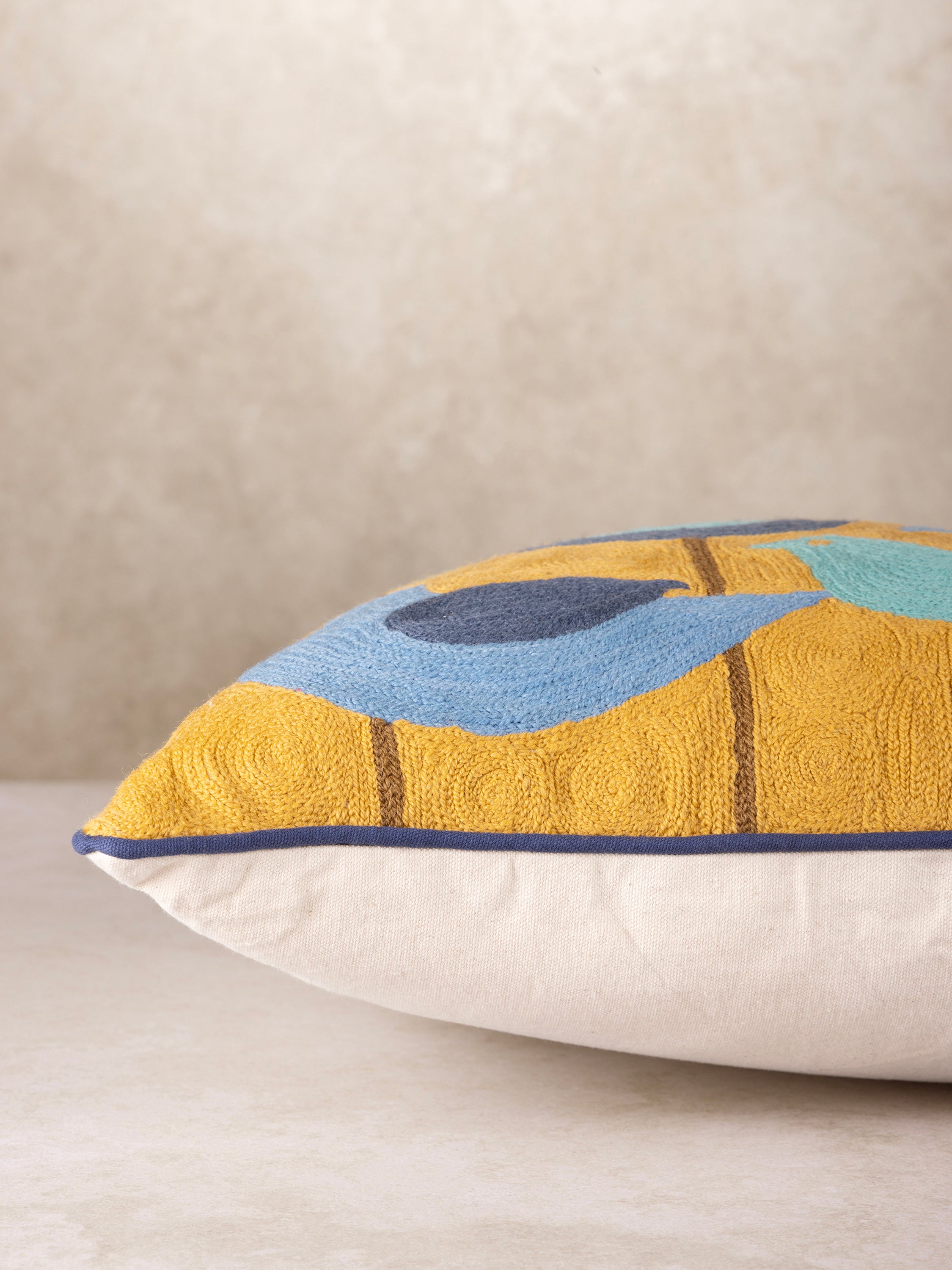 Handcrafted throw pillow with a unique mid-century modern bird design in shades of blue, perfect for adding a pop of color to any space