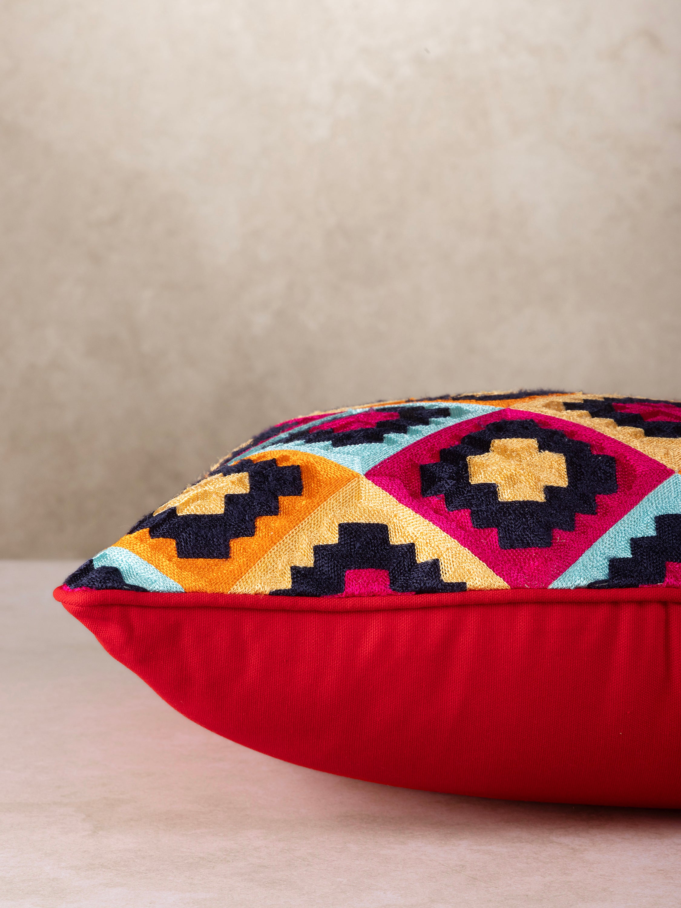 Artisan-made accent pillow with multicoloured geometric stitchwork on soft cotton — luxury home layer