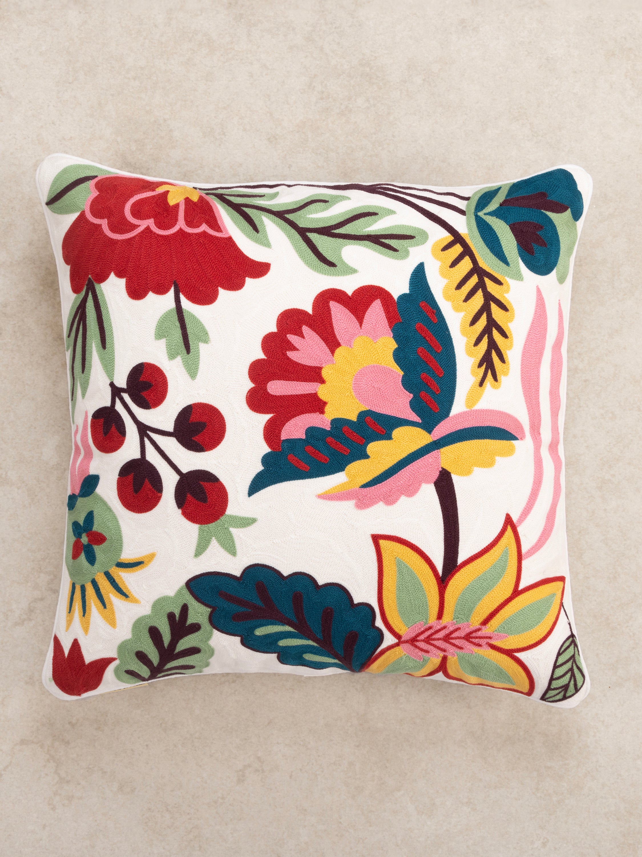 Decorative 20″×20″ pillow in natural cotton featuring bold embroidered blooms and tactile finish — refined home décor piece