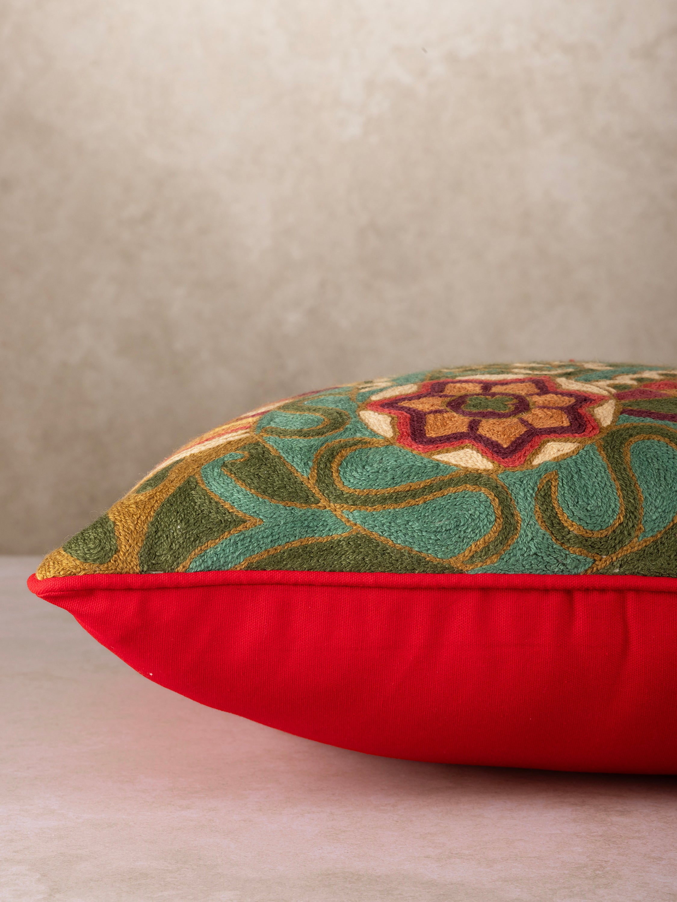 Square embroidered throw pillow with a detailed paisley-inspired pattern, adding a sophisticated and artistic touch to any spac
