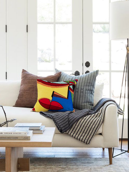 Natural cotton throw pillow 20″×20″ with multicolored embroidered motifs and artisan texture — elegant artisan accent