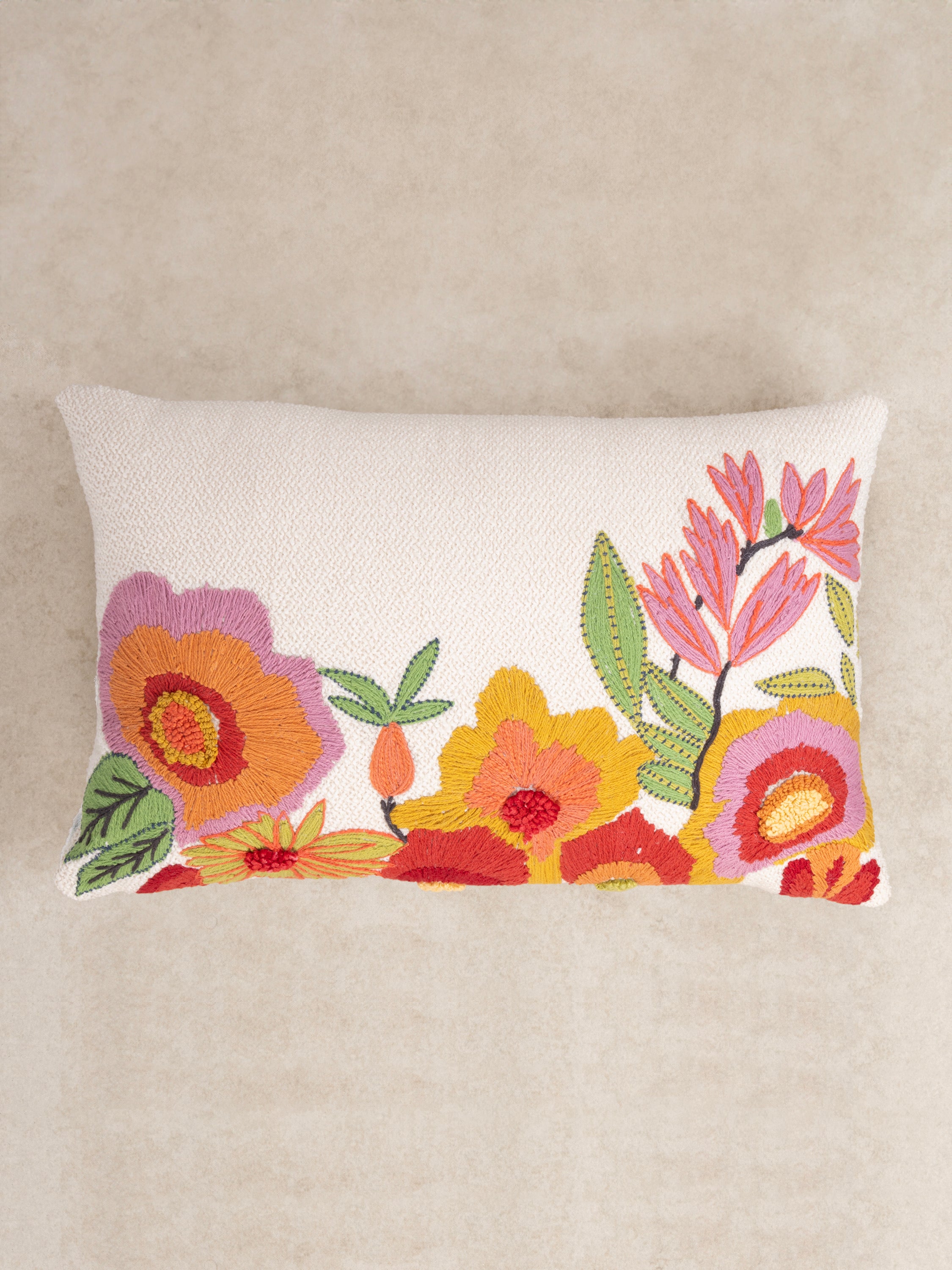 Handcrafted cotton throw pillow with vibrant multicolored pattern and fringe trim — artisan luxury accent