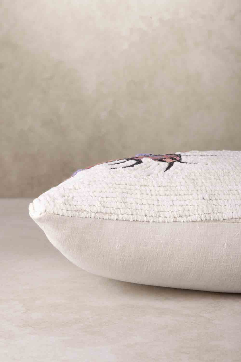 Side profile of rectangular throw pillow showing plush filled structure, soft rounded edges, and tassel corner detailing with smooth cotton backing
