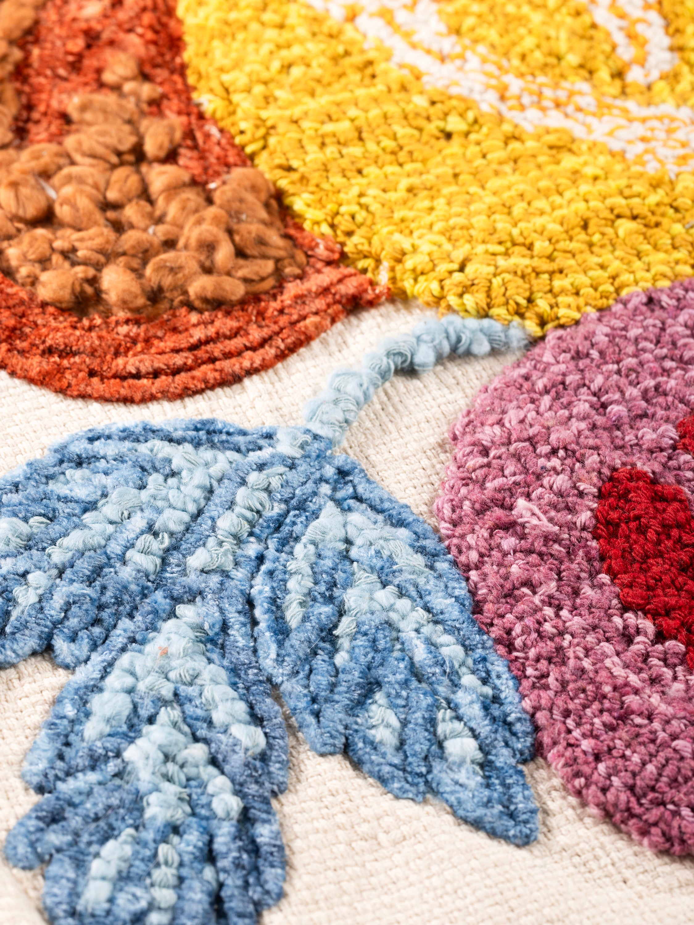 Textured cotton throw pillow with raised floral threadwork and vivid color palette — handcrafted design accessory