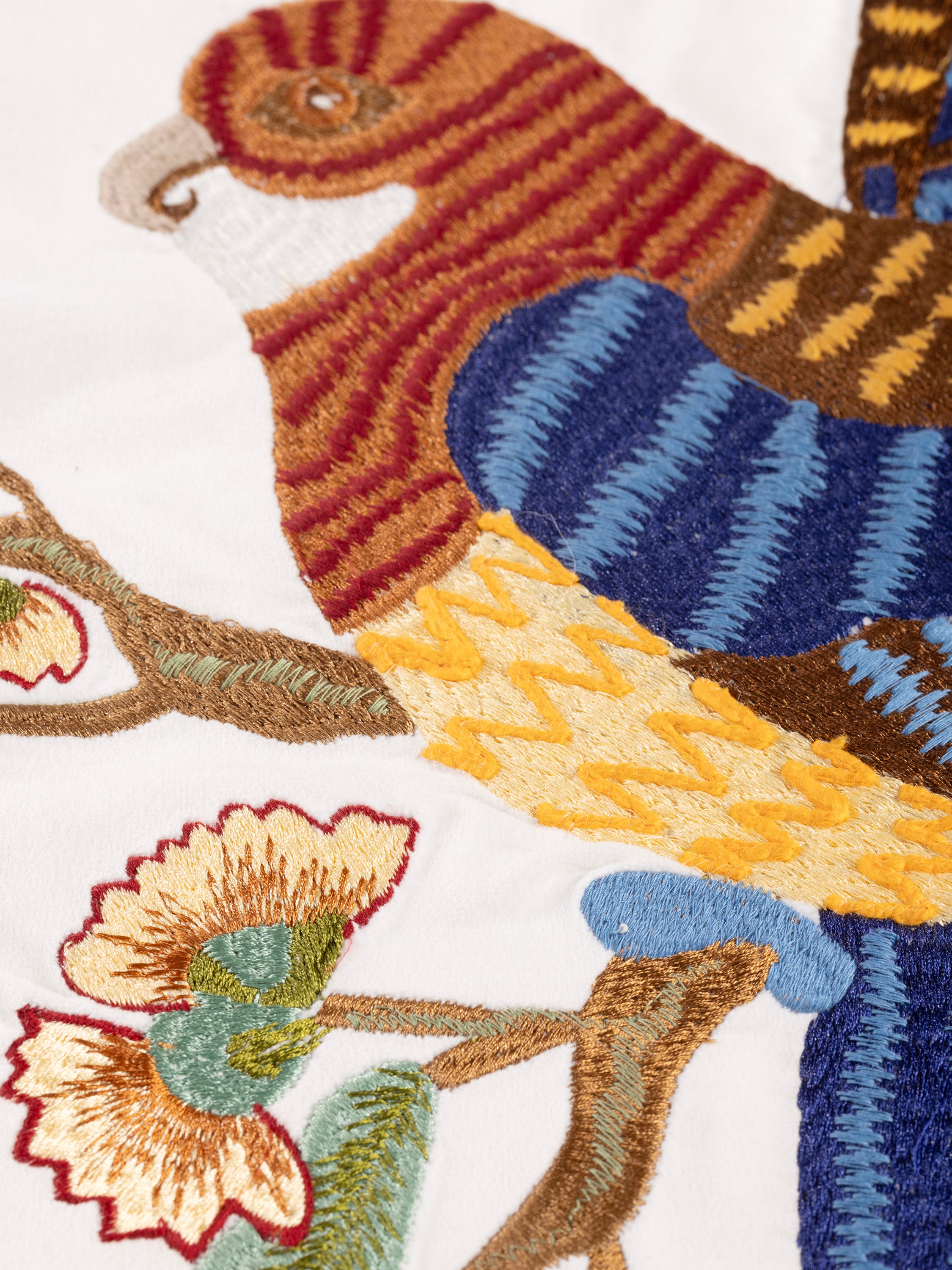 Decorative throw pillow with rich embroidery of birds and foliage on soft cotton — handcrafted design accessory