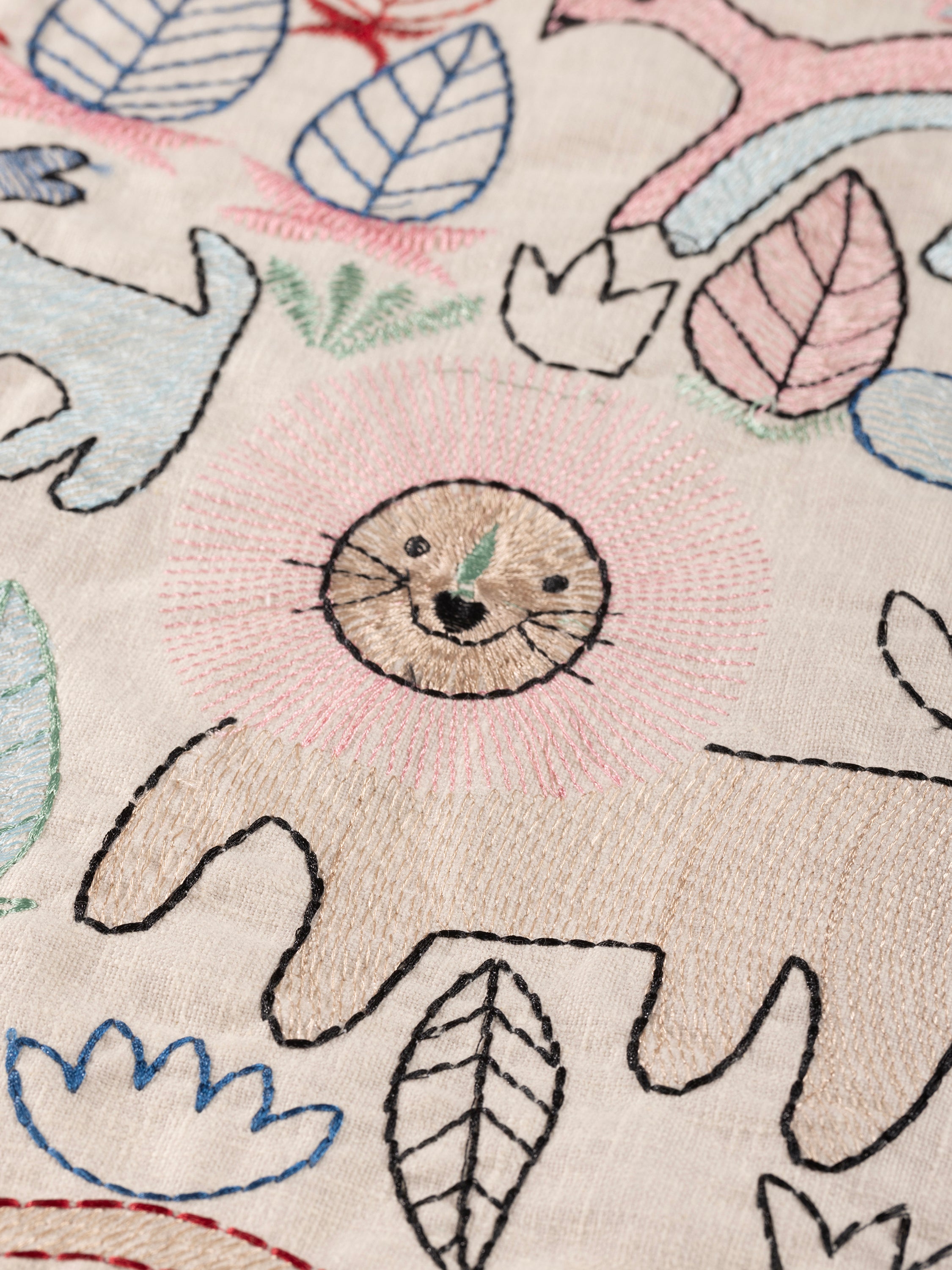 Decorative throw pillow with raised embroidery of animals and plants on soft cotton — crafted design accessory