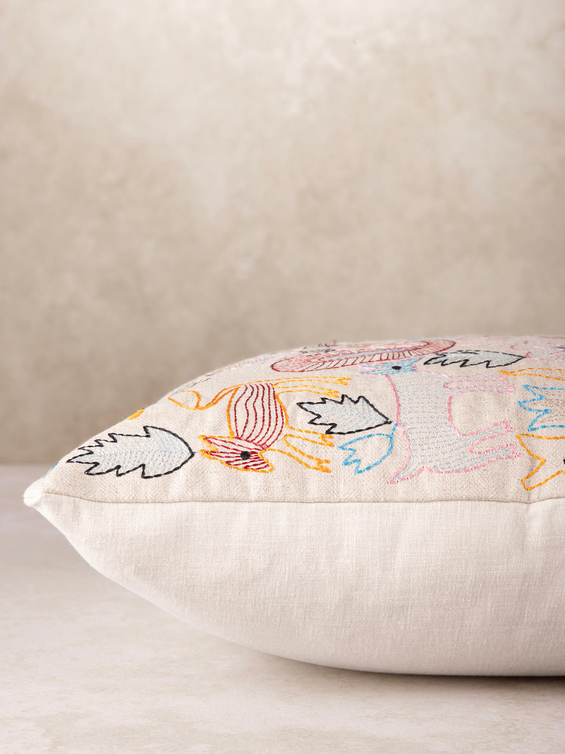 Artisan-made decorative pillow in cotton with lively embroidered animals and plants — luxury home layer