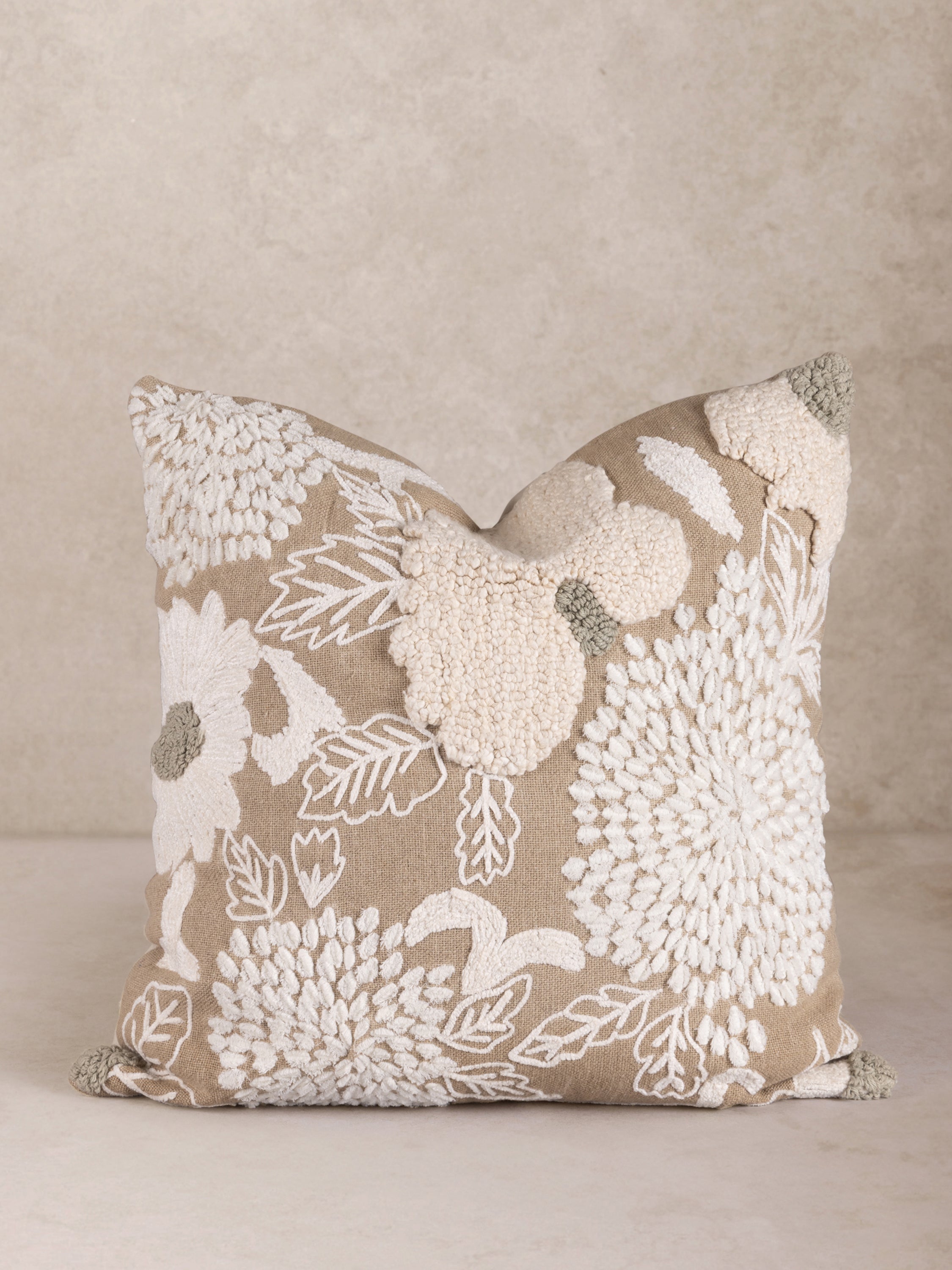 Hand‑crafted cotton throw pillow with tufted florals and subtle embroidery in neutral tones — artisan luxury accent