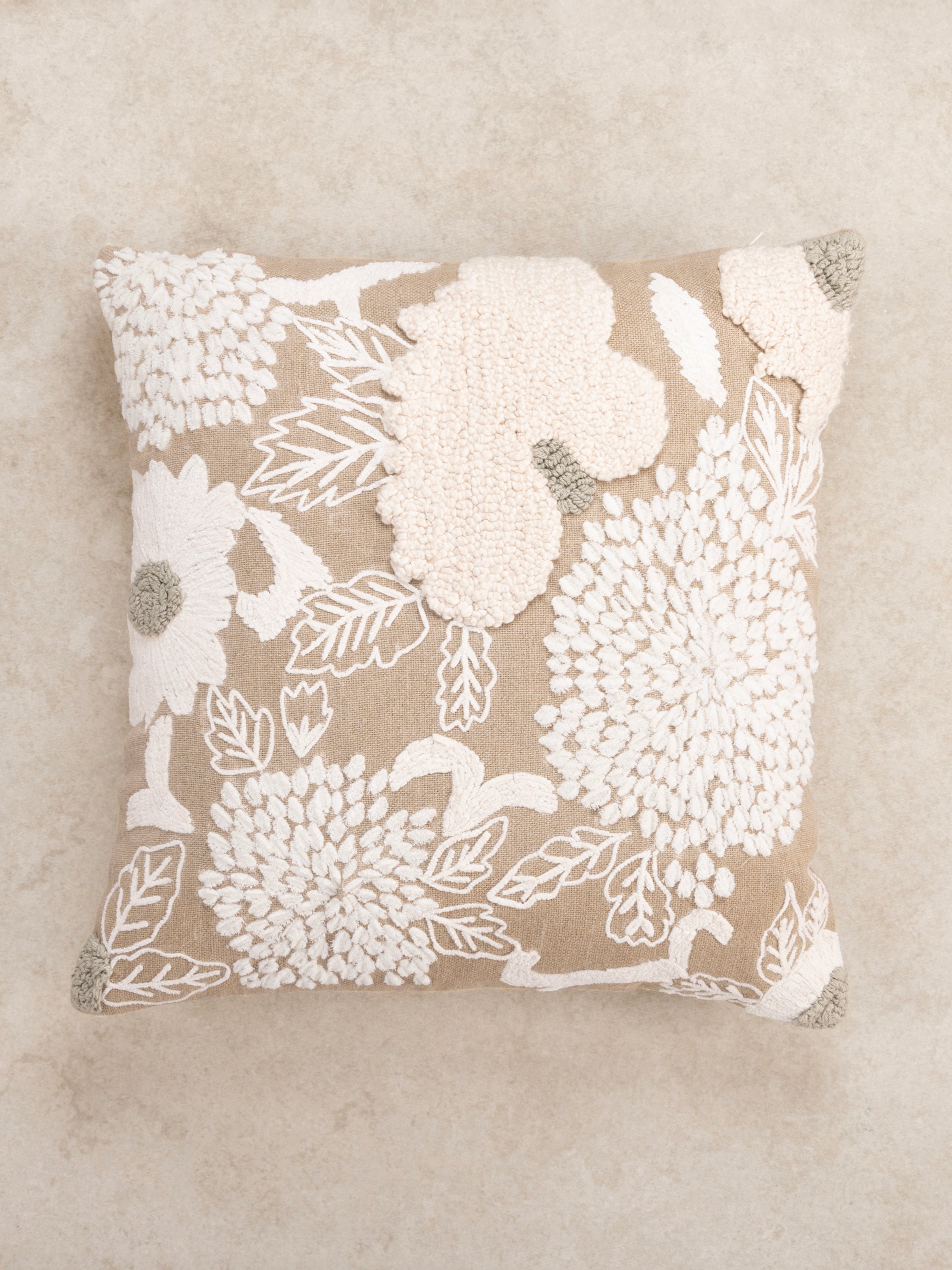 Textured botanical pillow 20″×20″ in natural cotton featuring raised tufted portraits of blooms and crafted stitch detail — refined home décor piece