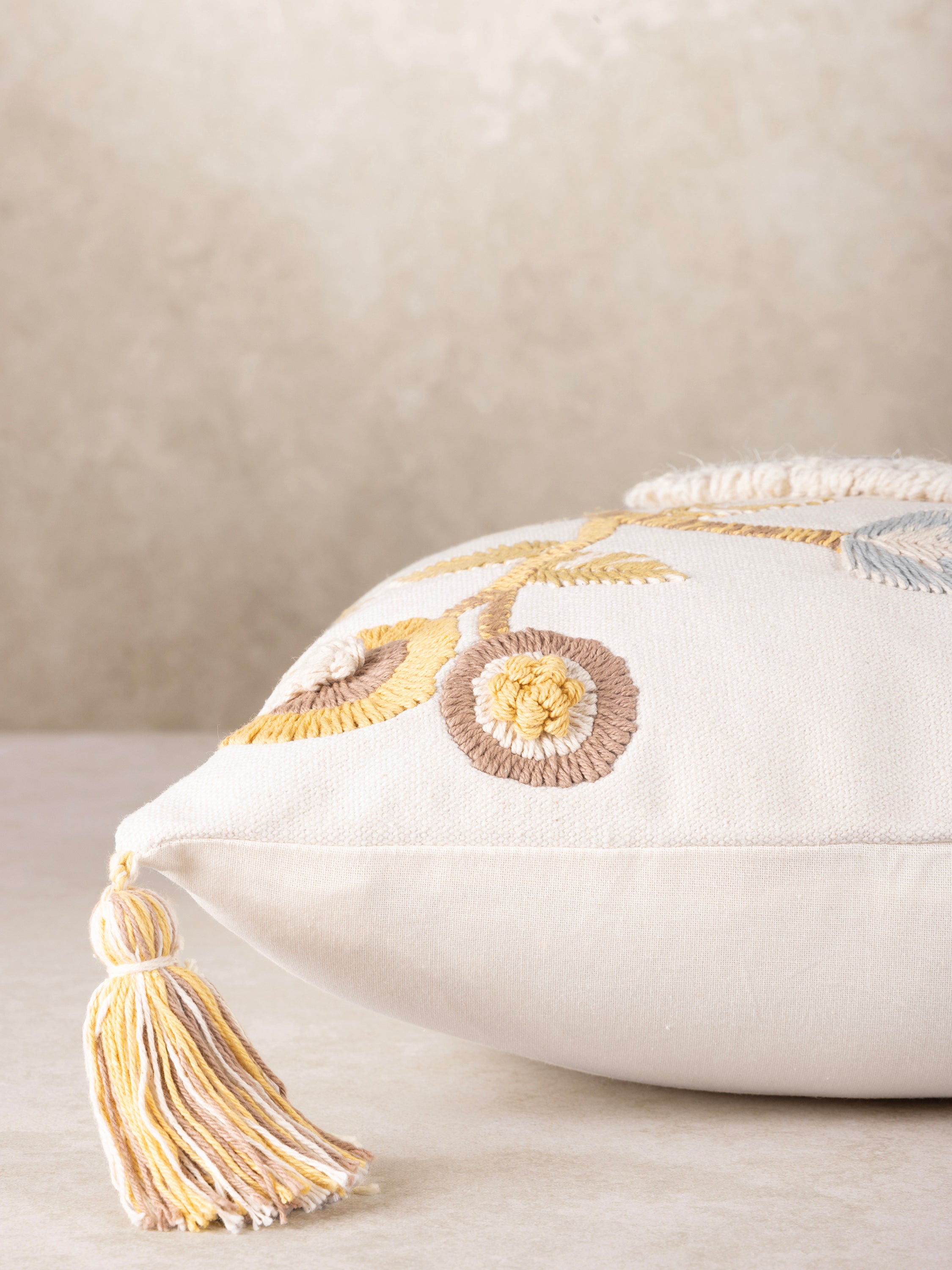 Artisan-made decorative pillow in cotton with intricate bird and floral stitchwork — luxury home layer