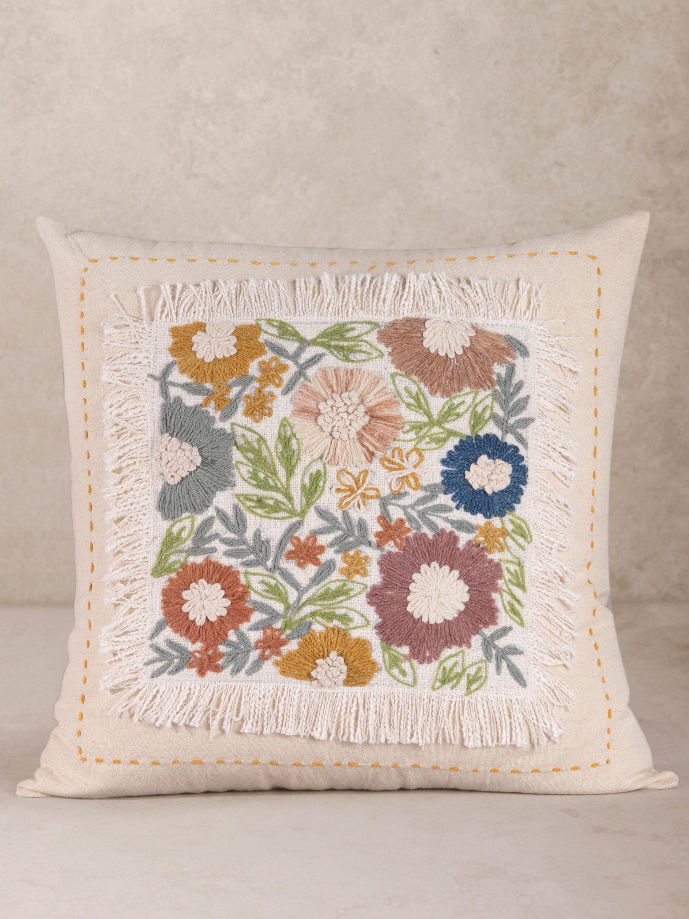 Hand-crafted cotton throw pillow with vibrant floral embroidery and fringe trim — artisan luxury accent