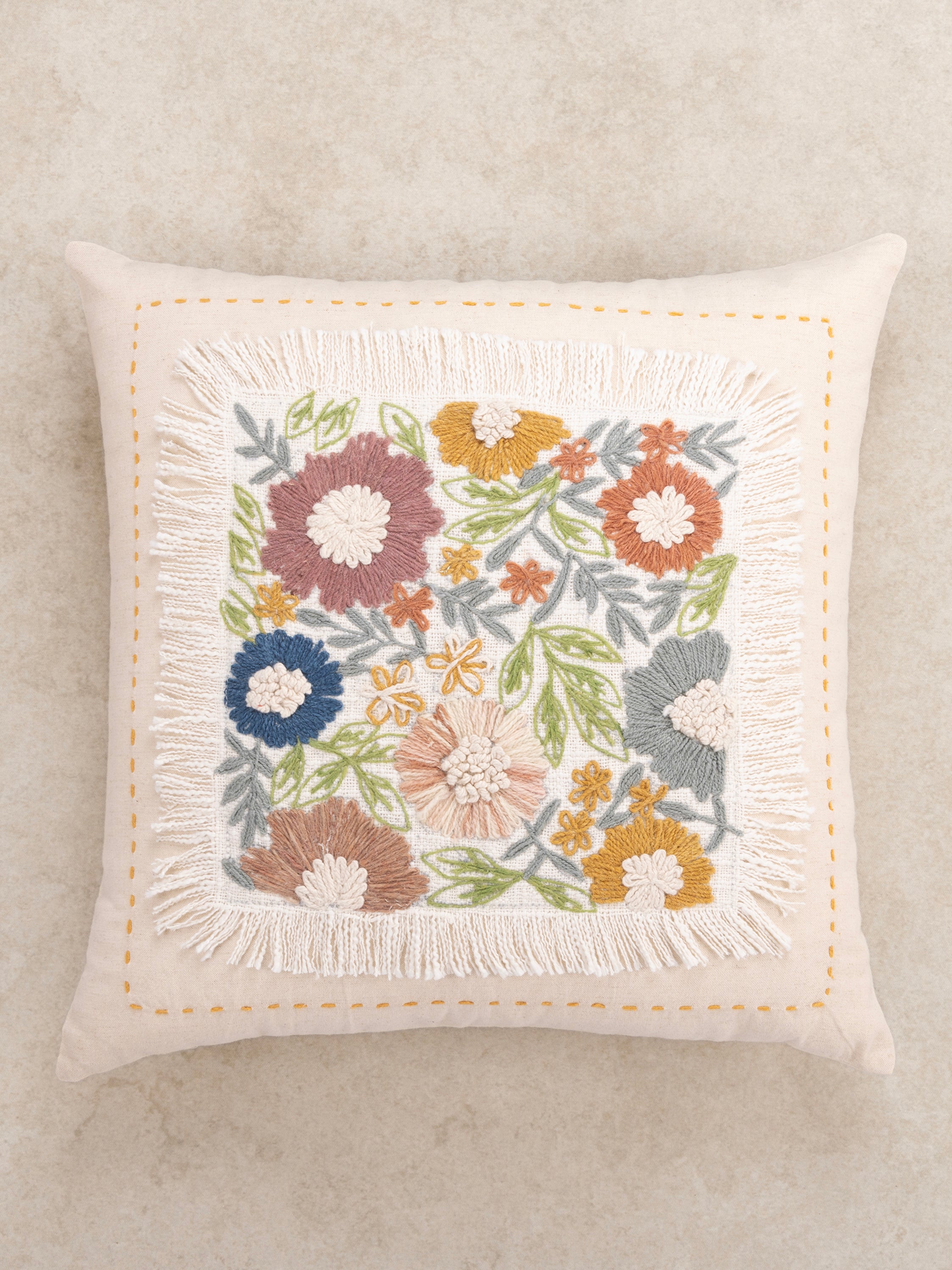 Textured embroidery pillow 20″×20″ in natural cotton with fringe edges and rich floral detail — refined decorative piece