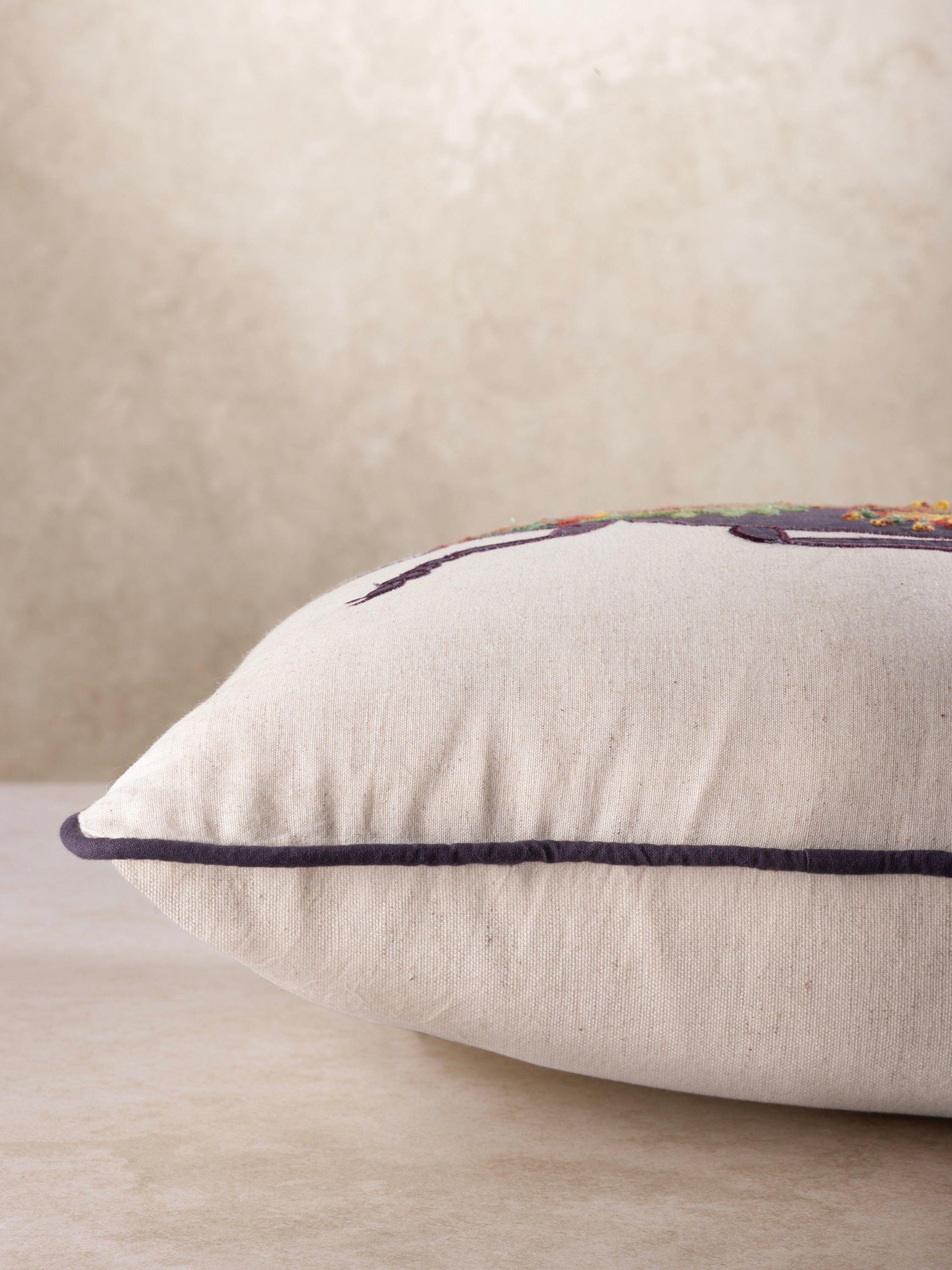 Artisan-made accent pillow in cotton with detailed beetle embroidery and textured surface — luxury home layer